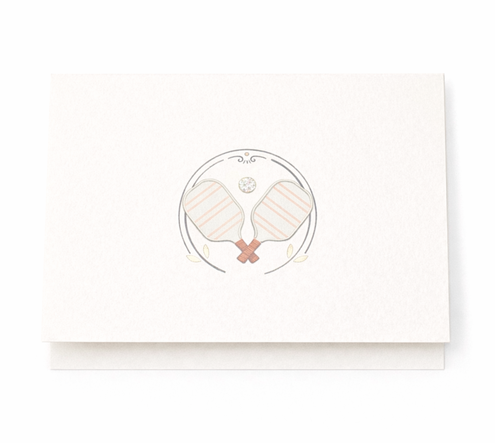 Pickleball notecard featuring crossed pink paddles inside decorative crest with crystal accent