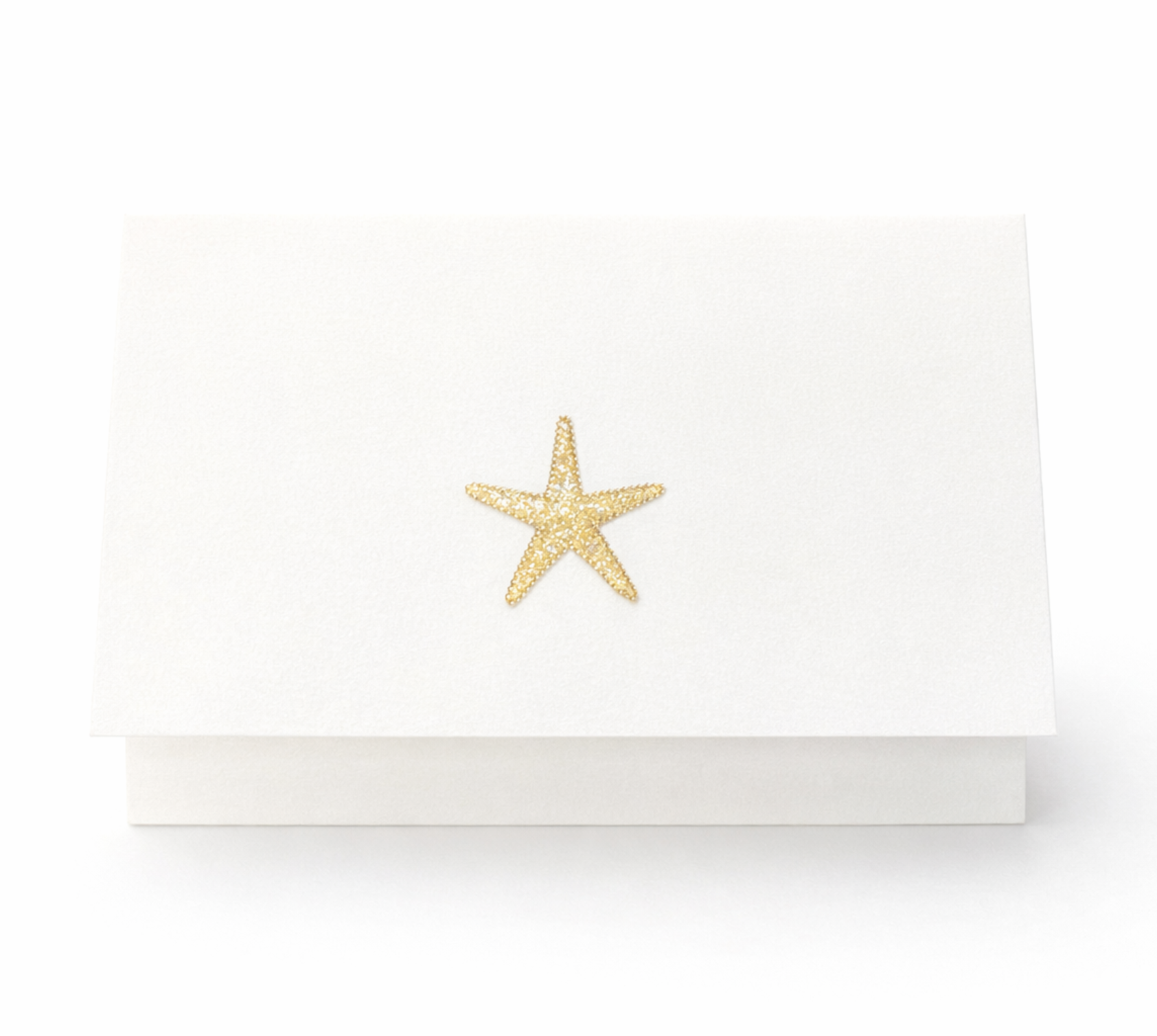 Folded starfish illustrated notecard from Salt Water stationery set on white textured paper