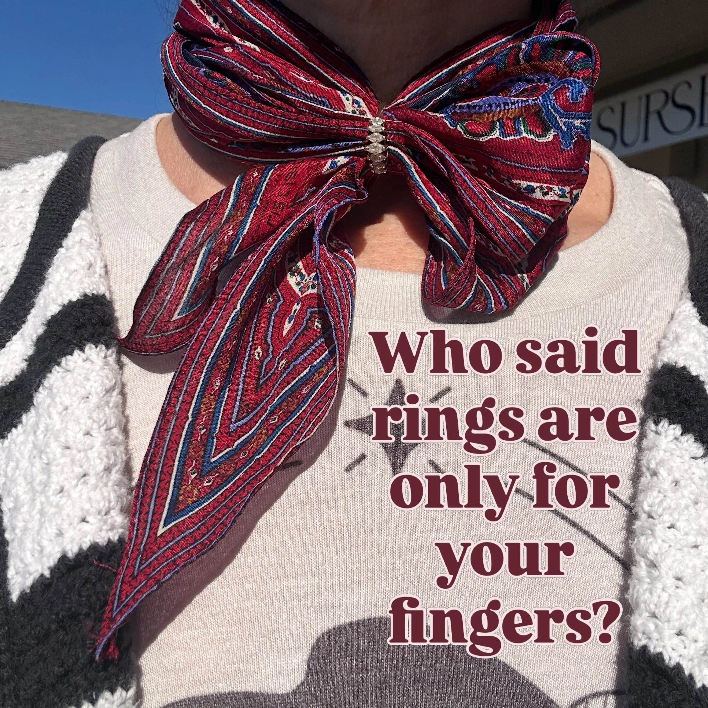 I have a necklace with an oval pendant on it that I like to pull my scarves through for a fun styling choice. My friend sent me a video of another stylist using a ring to hold her scarf in place, and I realized not everyone has an obscure open-pendan