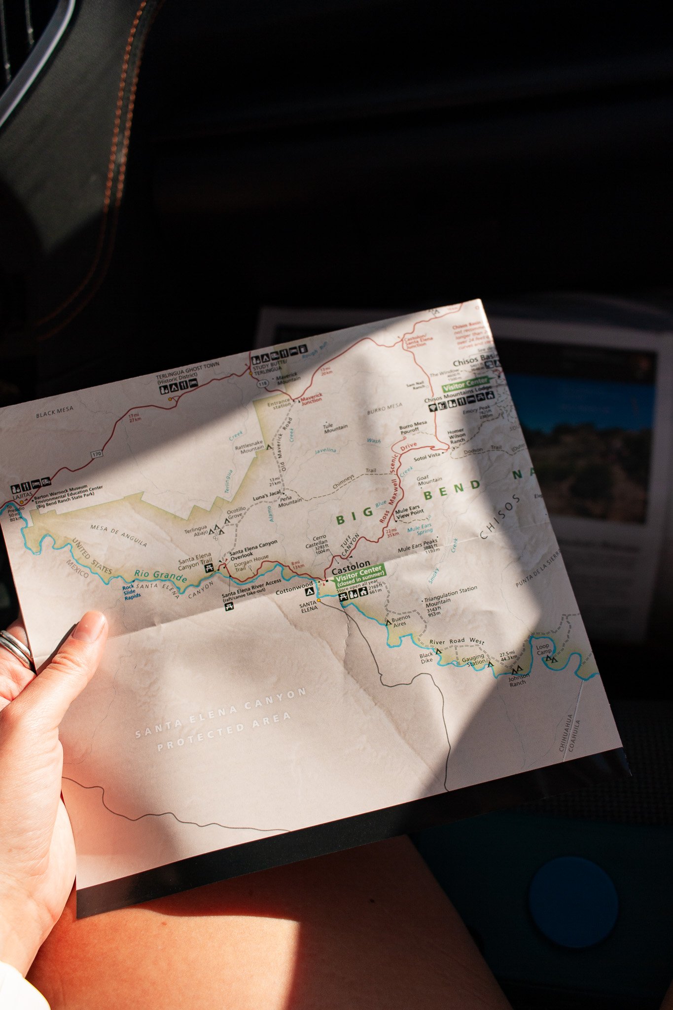 Person holds a map of Big Bend National Park, photograph by Beckie Irvin Studio