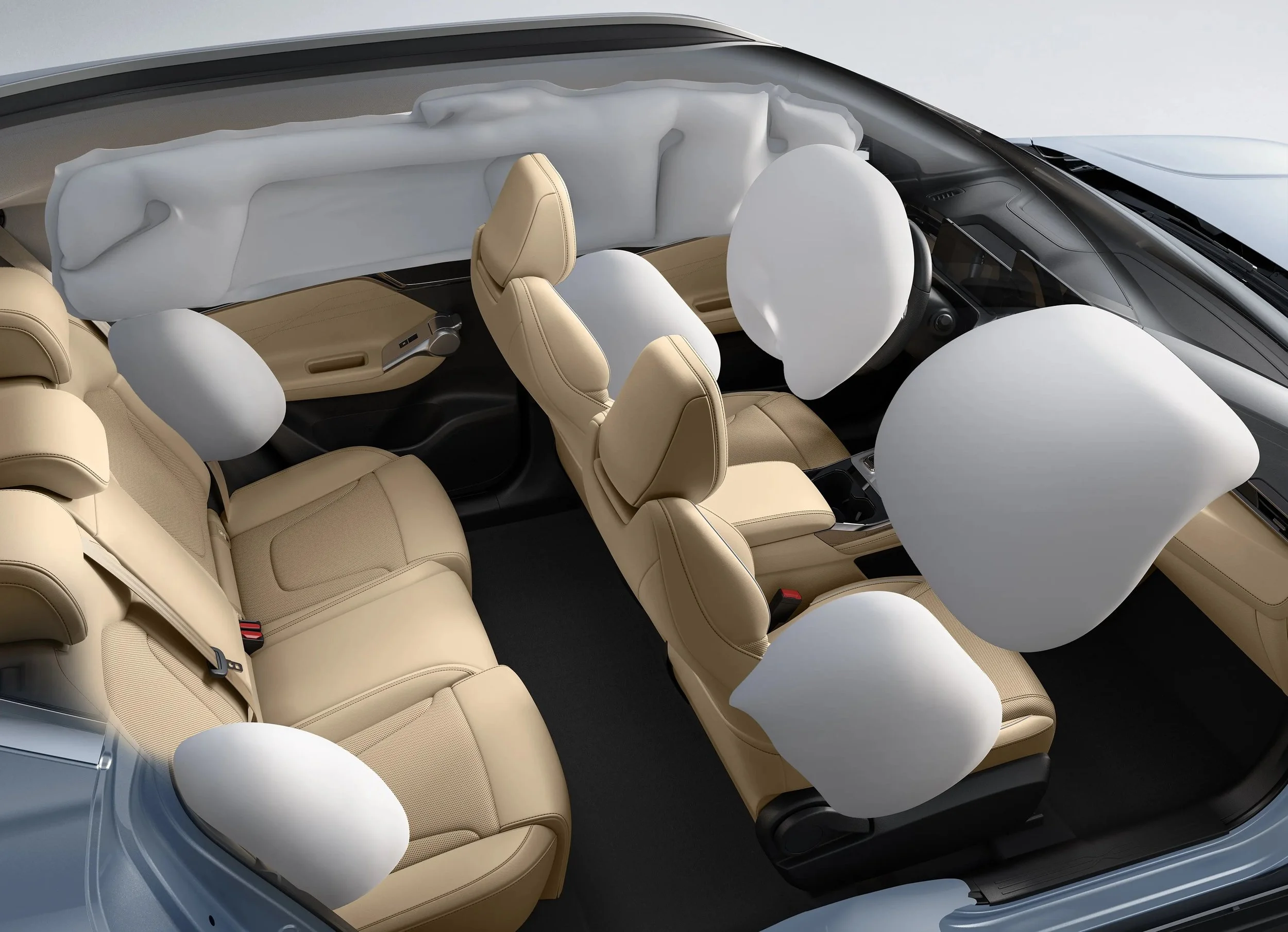 Interior de un automóvil con cinturones de seguridad hinchados en todas las filas de asientos.