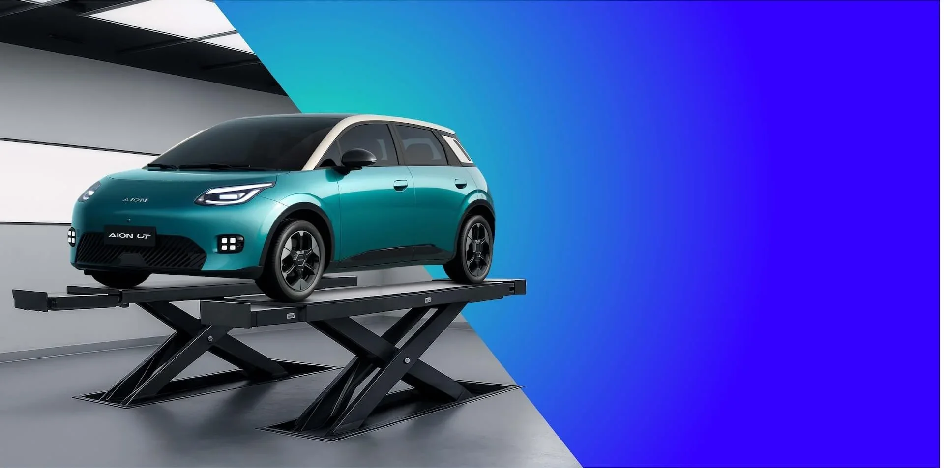 Coche eléctrico verde azulado en plataforma de exhibición en un entorno moderno y colorido.