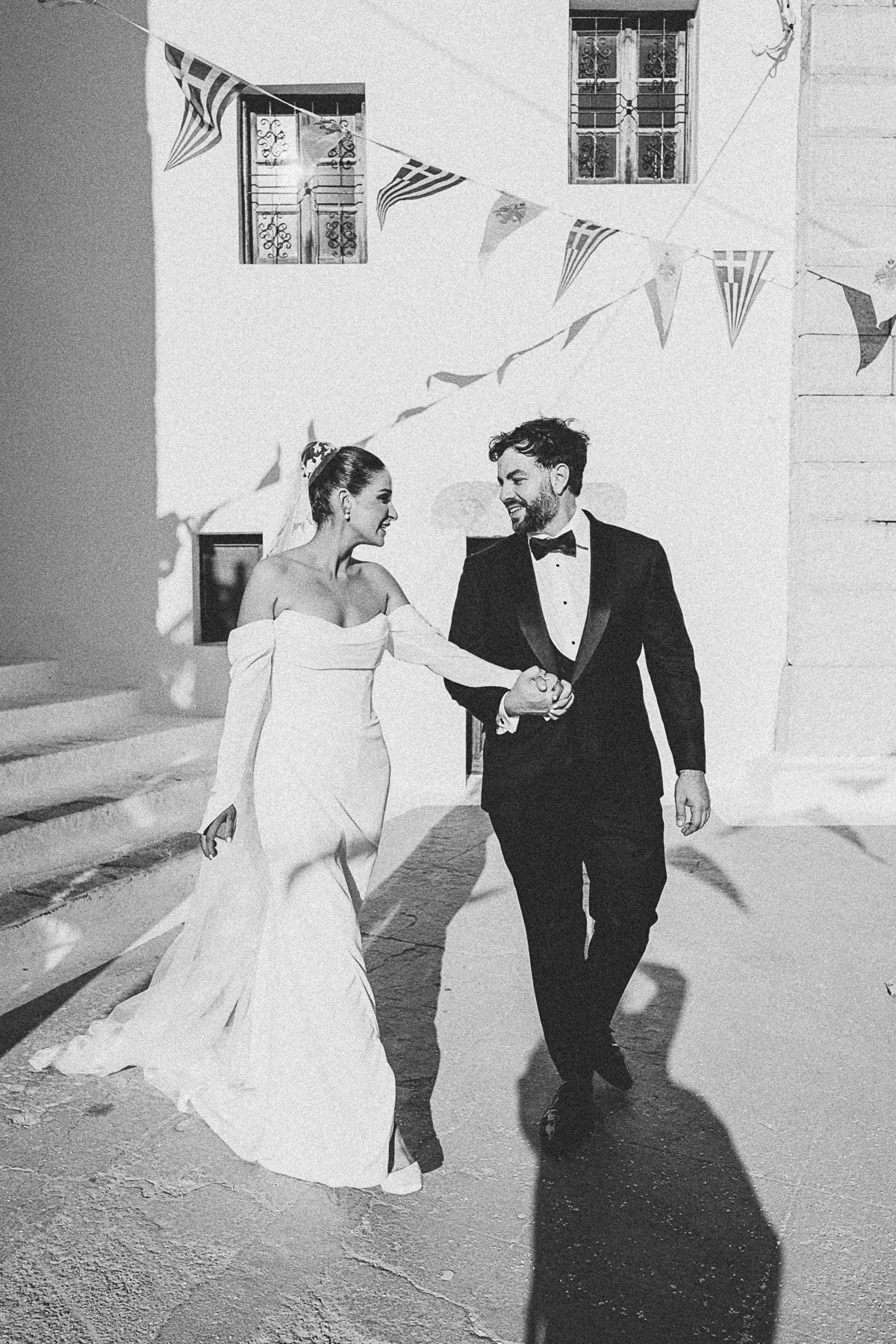 A joyful couple celebrating a destination wedding in mamma mia cinematic style on a Greek island, captured on 35mm film by Magdalene Kourti Photography