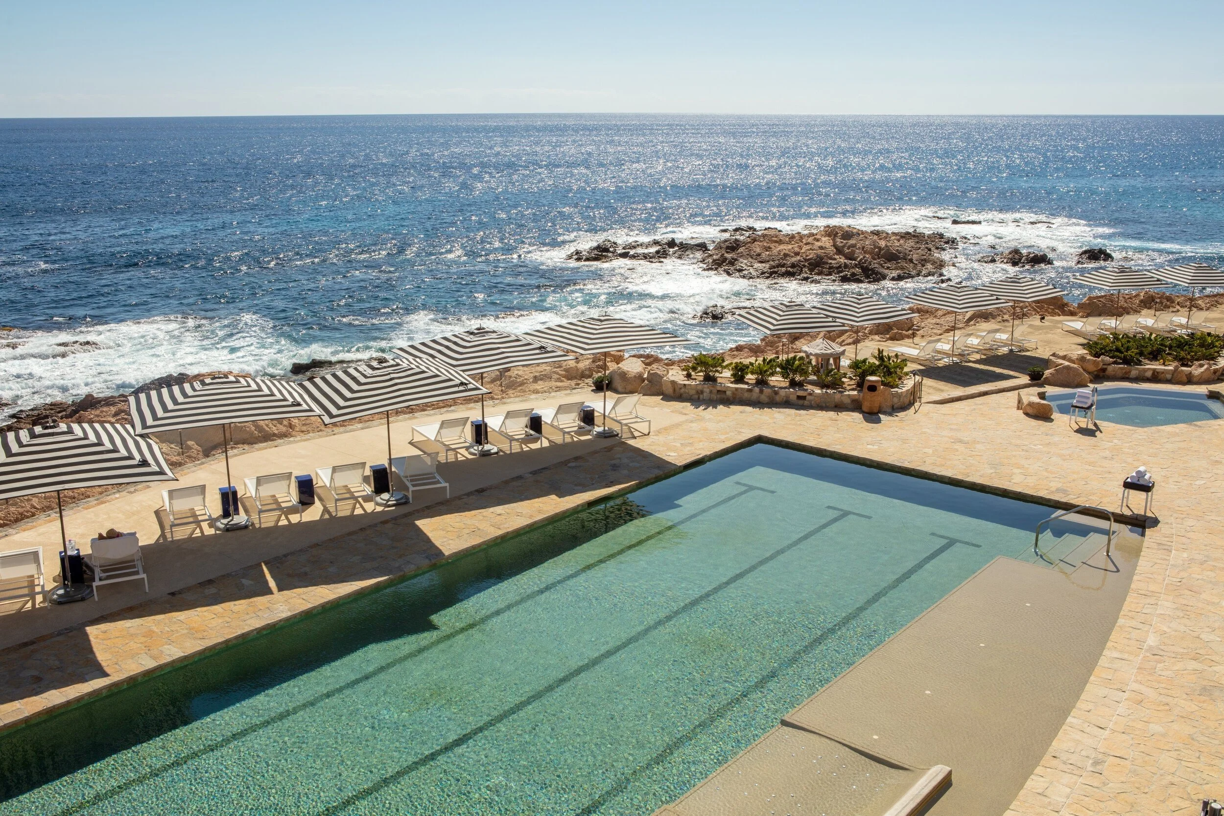 maravilla-los-cabos-infinity-pool-striped-umbrellas-coastline.jpg