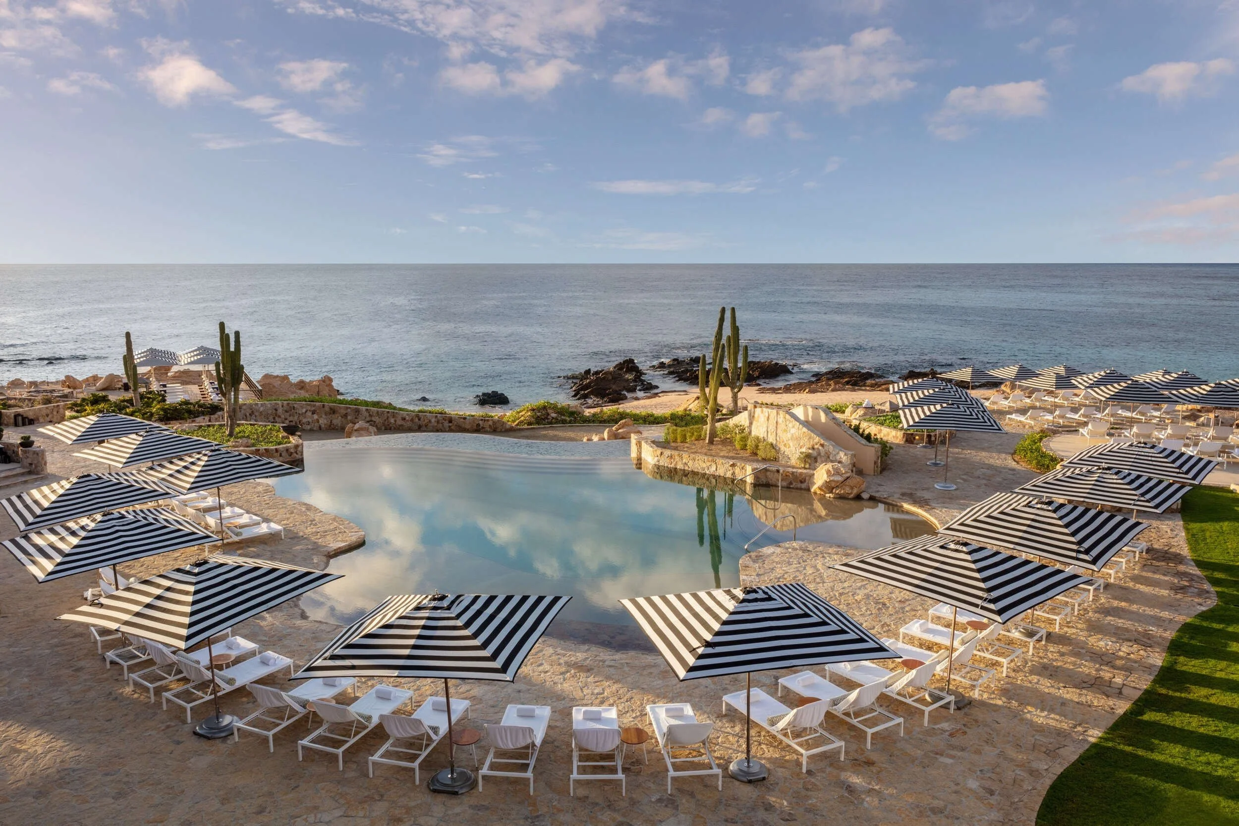 maravilla-los-cabos-pool-striped-loungers-aerial-coastline.jpg