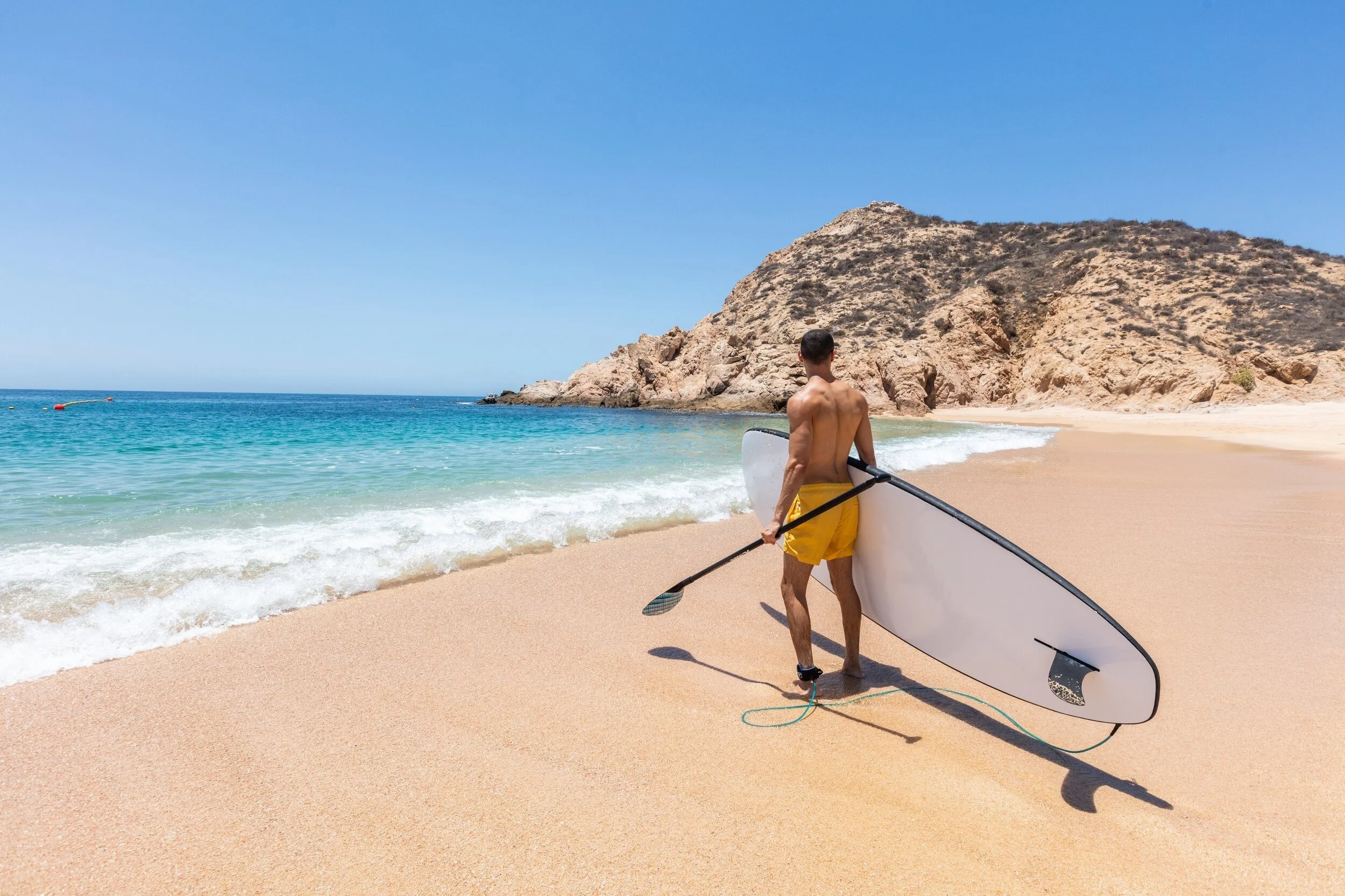 maravilla-los-cabos-man-surfboard-beach-cliffs.jpg
