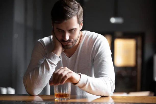 Addicted man thinking of enrolling in online alcohol treatment