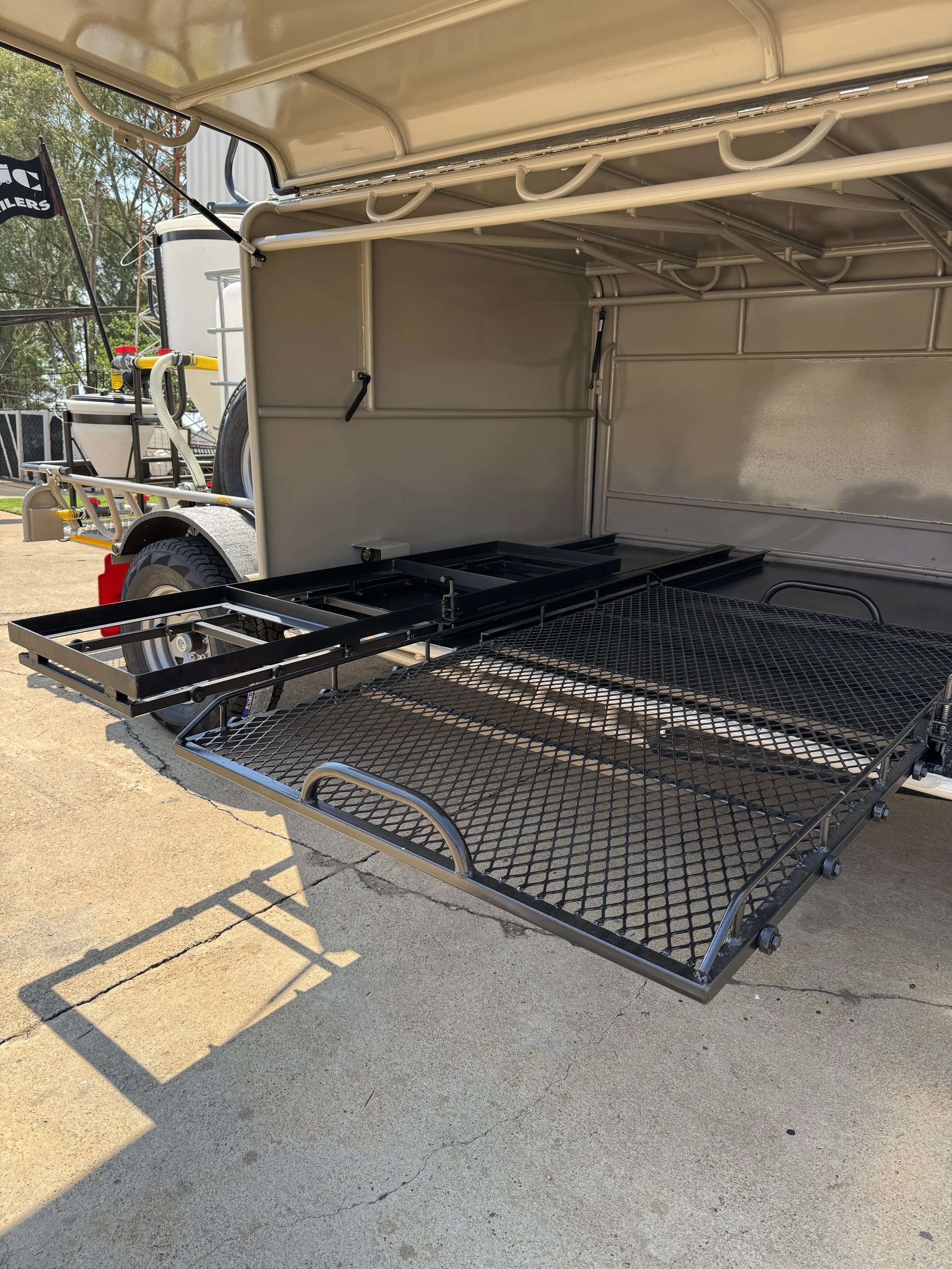an open trailer with metal shelving inside