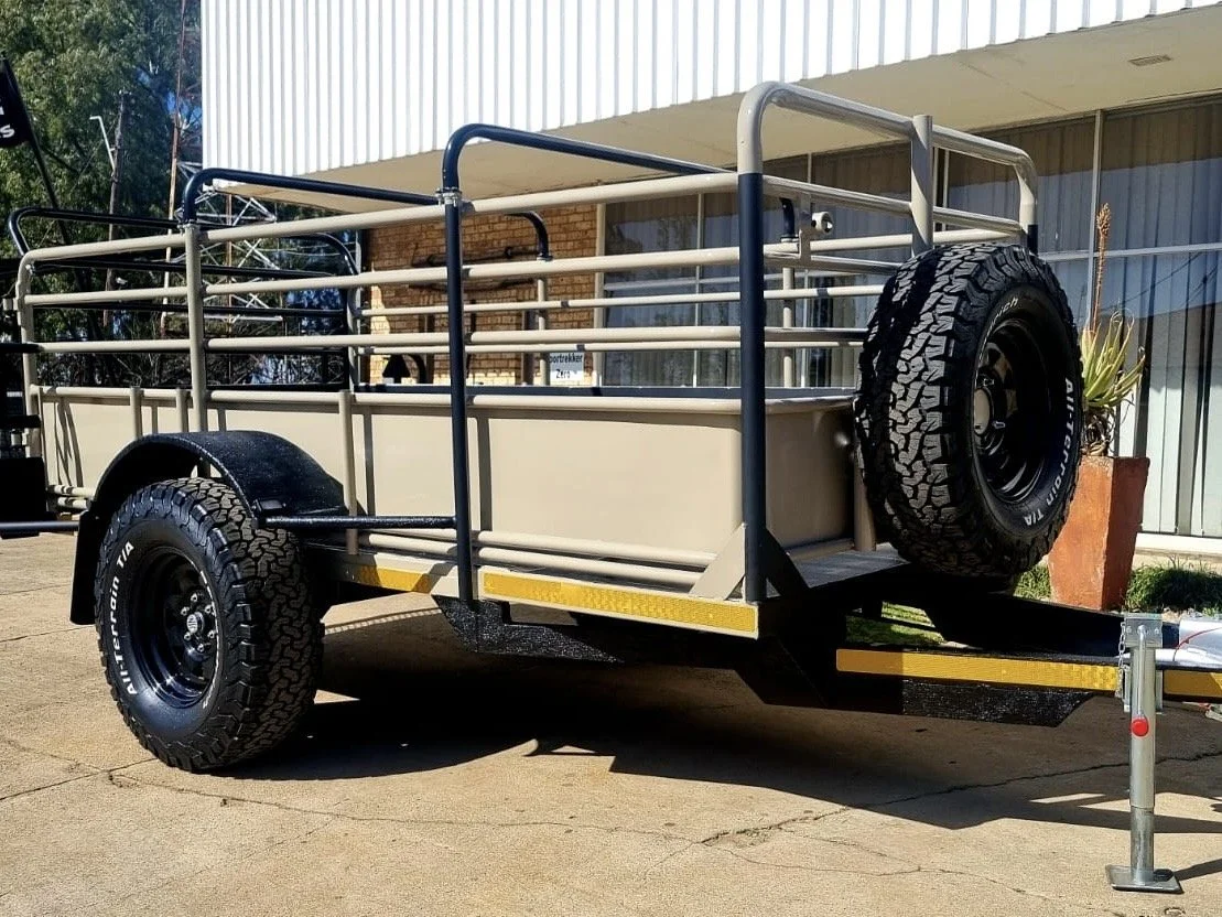 Utility trailer with metal railings and spare tire