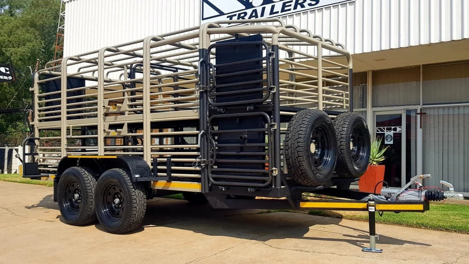 Livestock trailer with metal bars and wheels