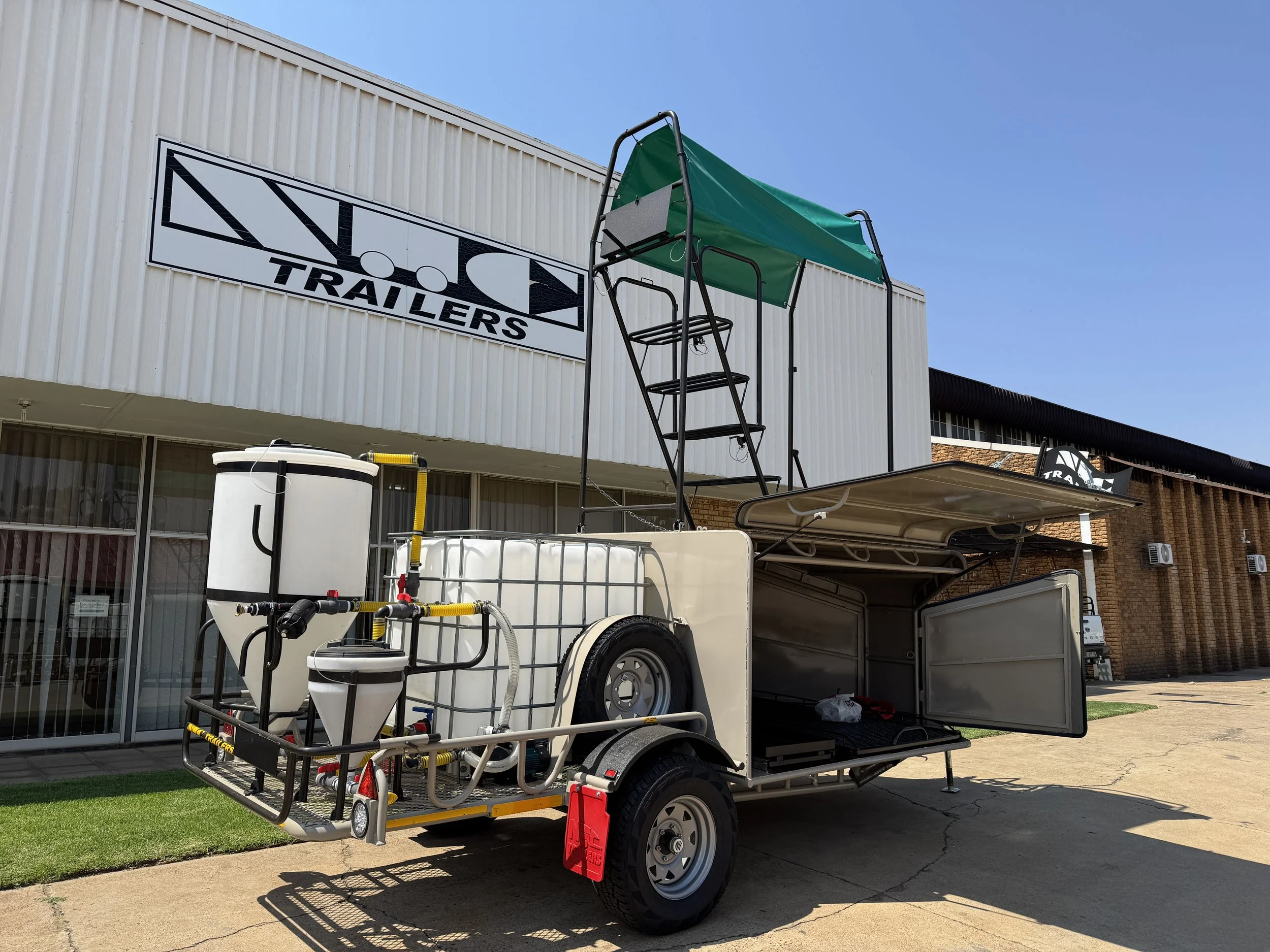 Drone trailer with tanks and a green canopy