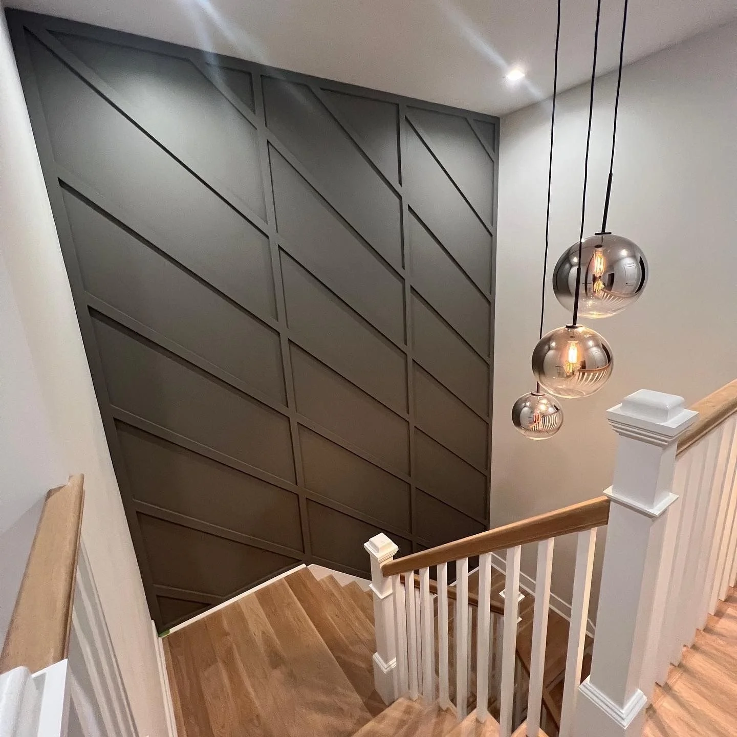 Dark gray Iron Ore accent wall with decorative panel trim in Gaithersburg MD – interior feature painting