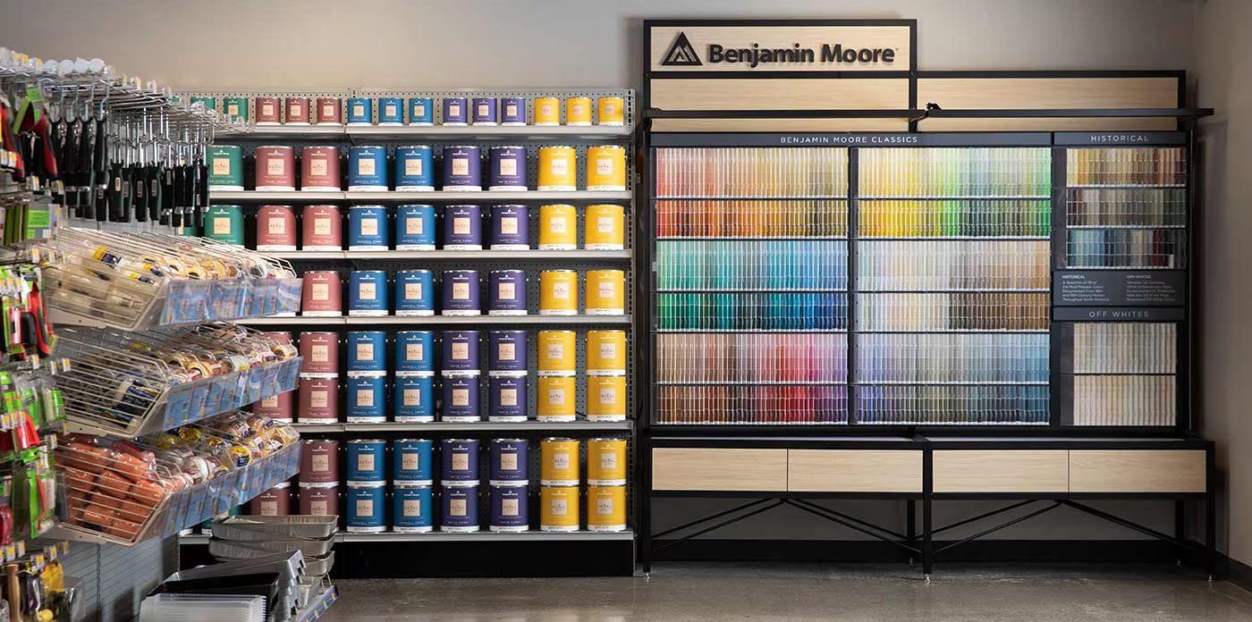 Benjamin Moore paint display in a Howard County retailer, showing a wide range of color swatches and paint cans for homeowners choosing paint.