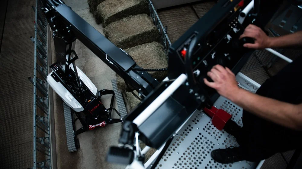 Man operates HYRAX aerial lift from the basket while the boom is fully extended