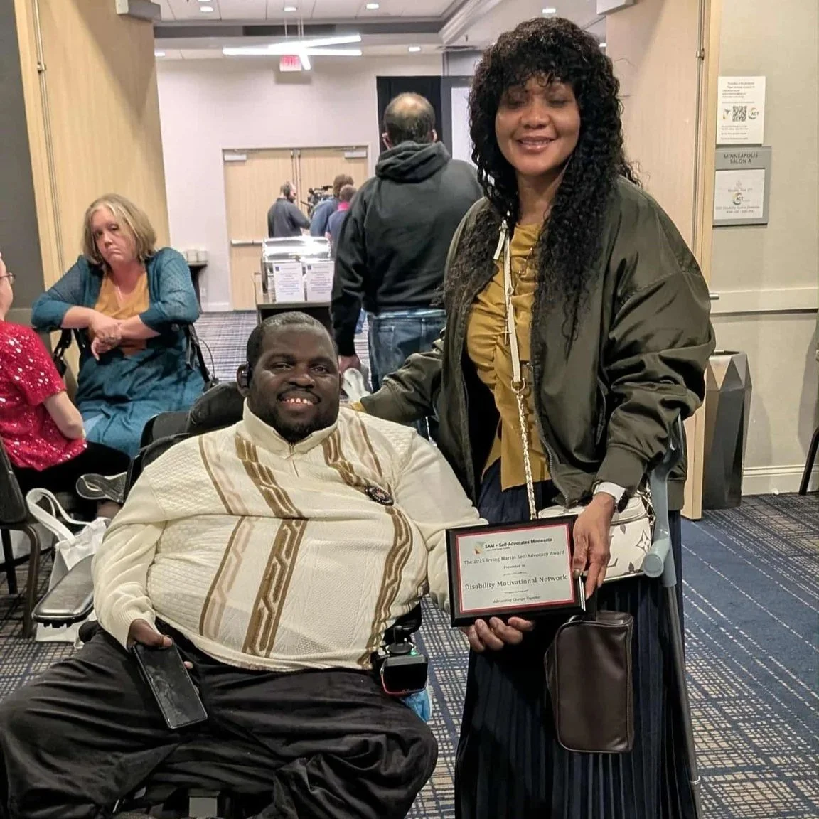 Prince and Agnes of DMN posing with their award. Photo in the halls of the hotel - both are smiling.