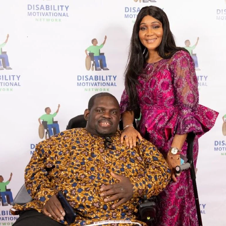 Prince wearing an orange and black top sitting next to Agnes who is wearing a pink dress.