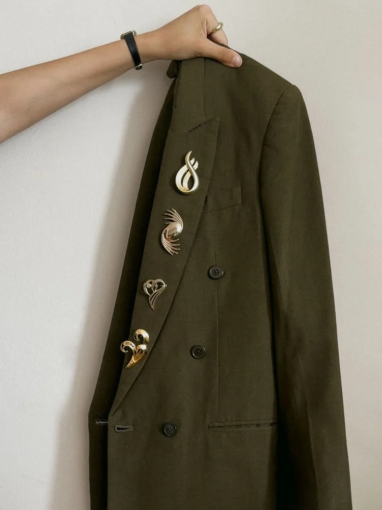 Gold Brooches on Blazer Club Riante.jpg