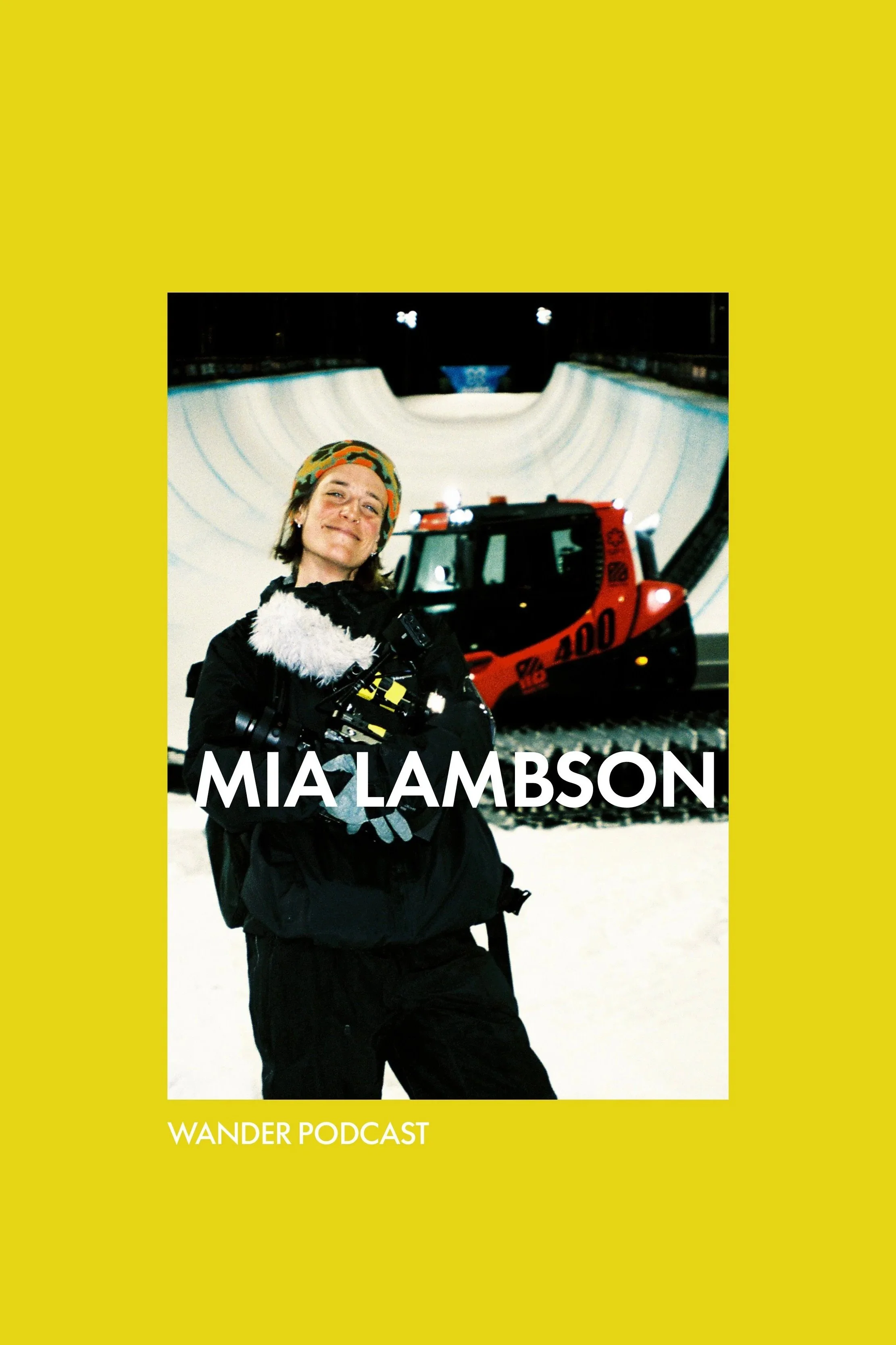 Cover of Mia Lambson's Wander Podcast featuring her standing in front of a snow-covered skatepark with a red excavator in the background, wearing a colorful hat and black jacket.