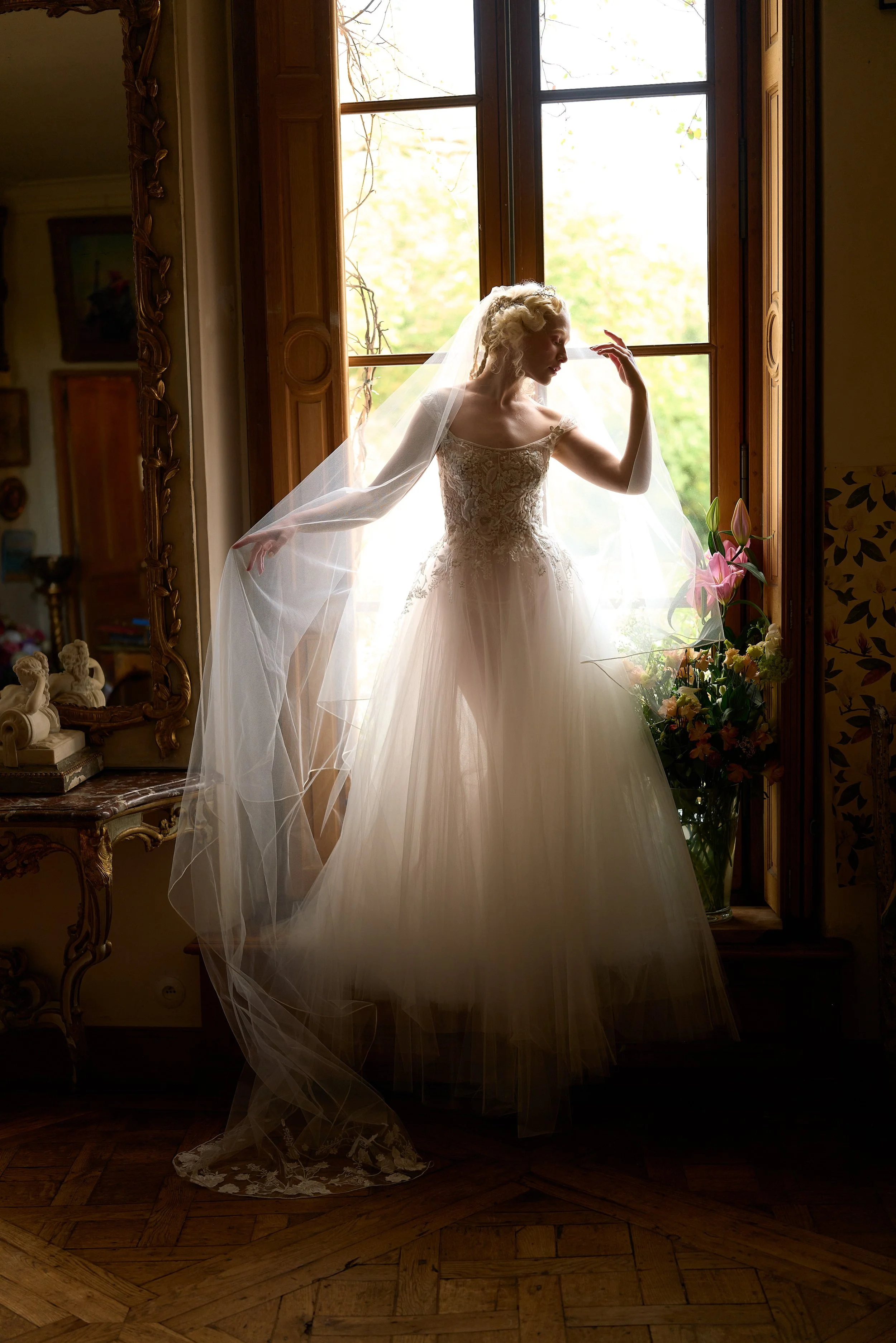 The Brynn Gown in ethereal tulle embroidered in Italy with hand sewn appliqué with tulle underskirt, matching detachable train, veil and lingerie. Part of our #bridaltoboudoir collection