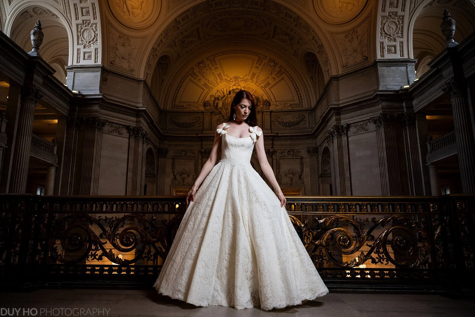 The Daniella Gown in interacted French lace and silk Peau de Soie from Como, Italy. Lined and petticoat in silk organza, side seam pockets and silk covered buttons. Bows optional.