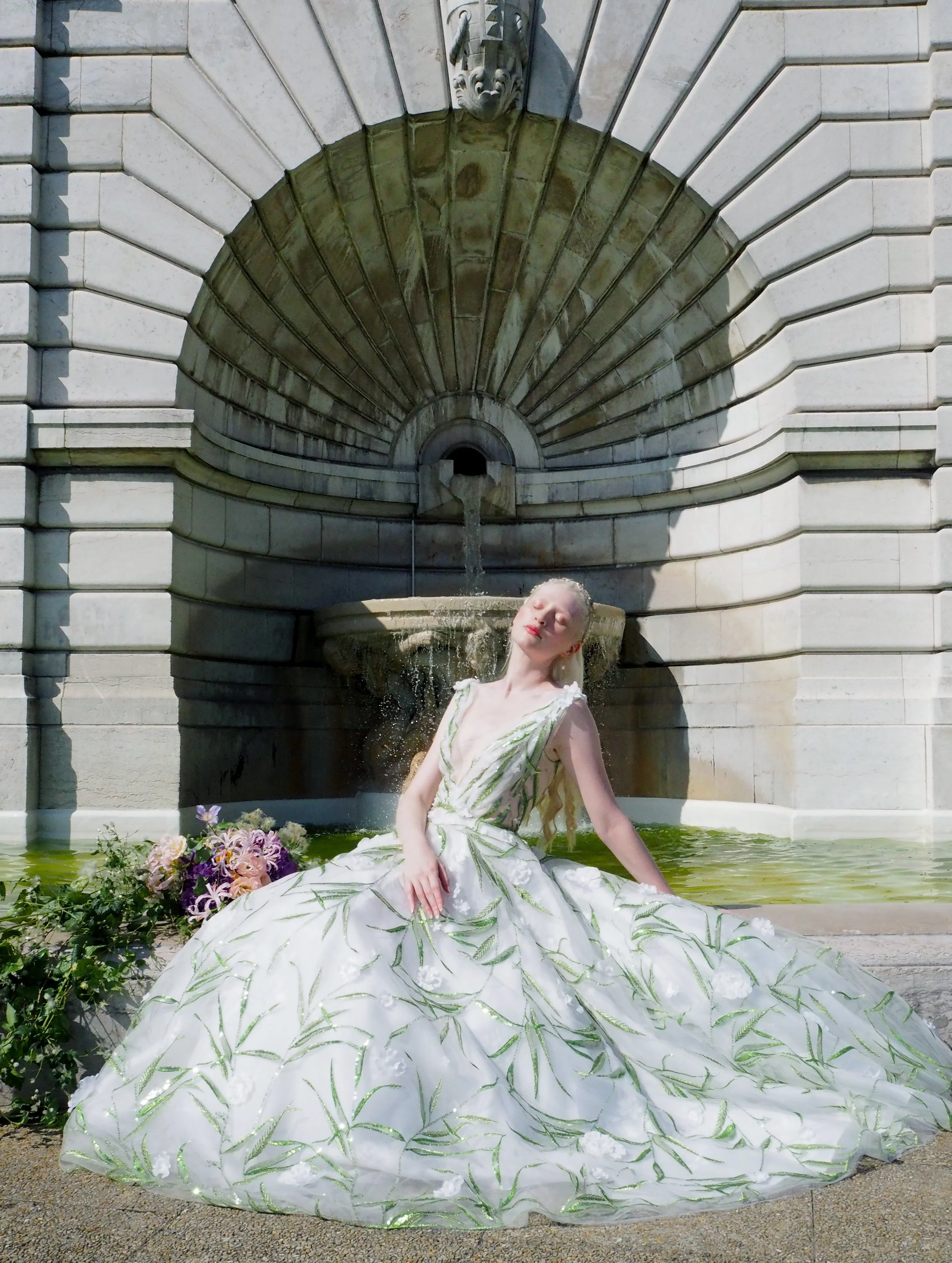 The Claire Gown in sequined, embroidered tulle from Italy with hand-sewn appliqué, 3-D silk organza flowers over a hand-painted silk organza base      