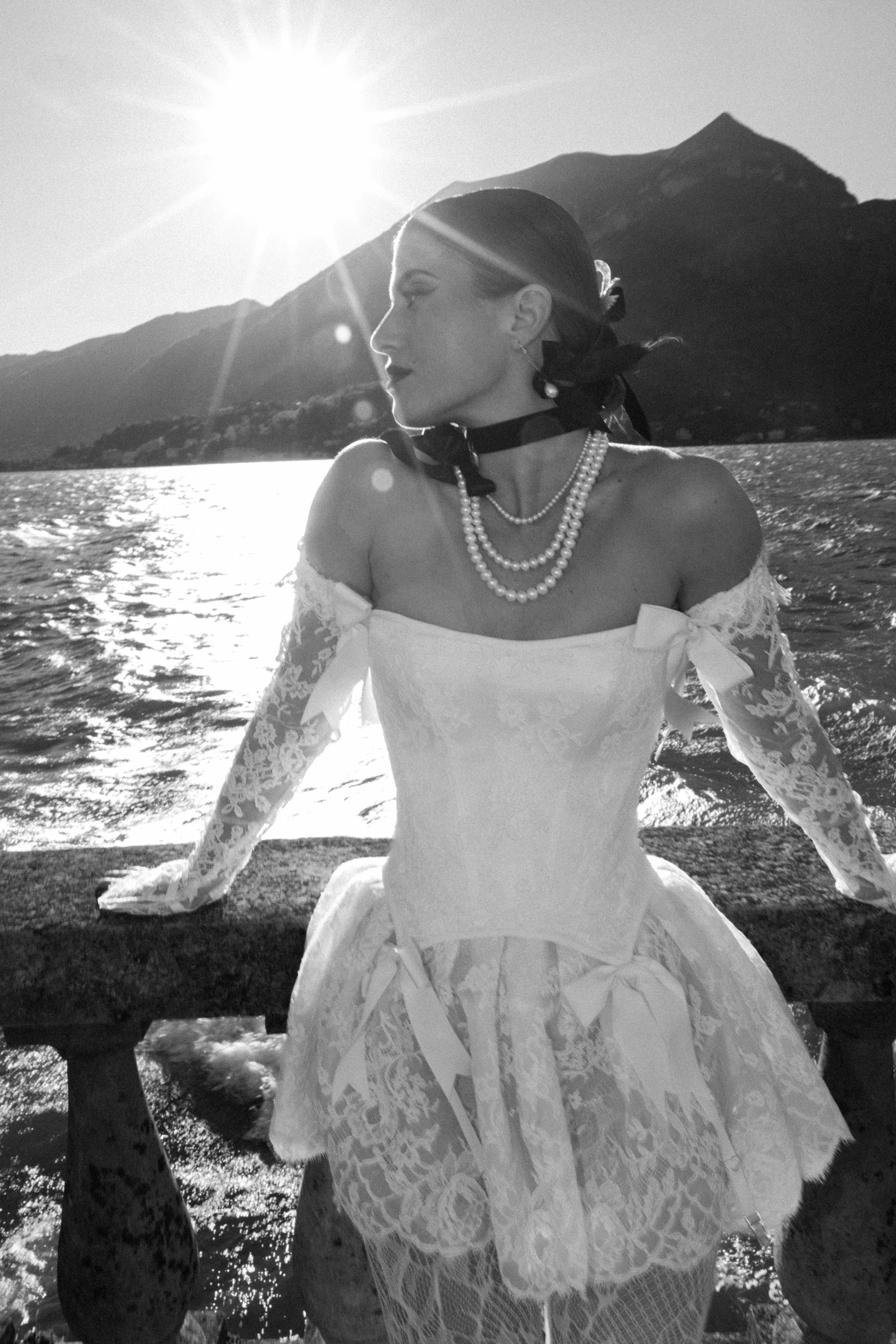 The Etain lace corset bodice with long sleeves and micro mini skirt made of French lace and Italian silk. Optional Bow and garter details.
