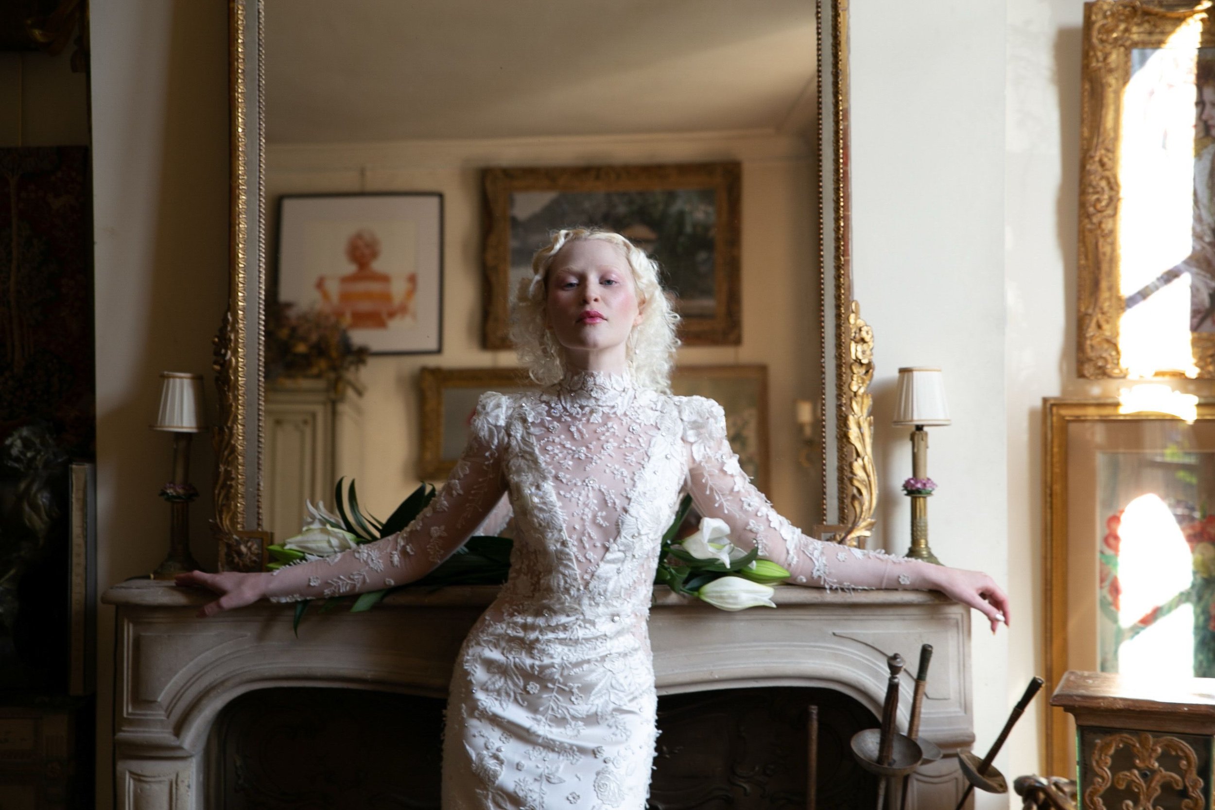The Claudette Gown is a long sleeved column gown with a high collared neckline in supple double faced satin and embroidered tulle made in Como, Italy. The belle of our “Savoire Faire” with over 250 hours of hand-sewn appliqué and beading