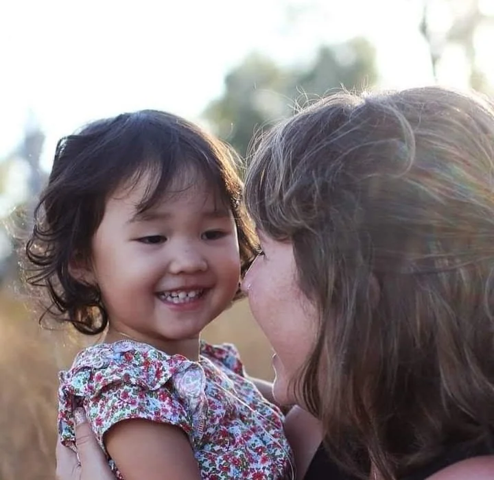 Amber De Vogt and toddler smiling