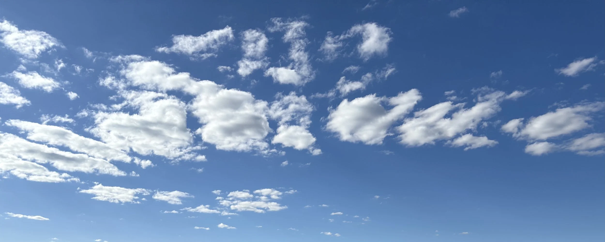 Blue sky with scattered white clouds