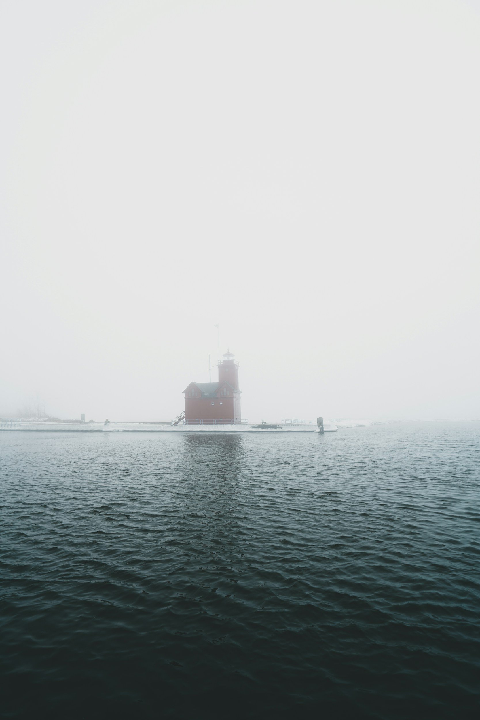 Wintry photo of Holland's lighthouse through the fog