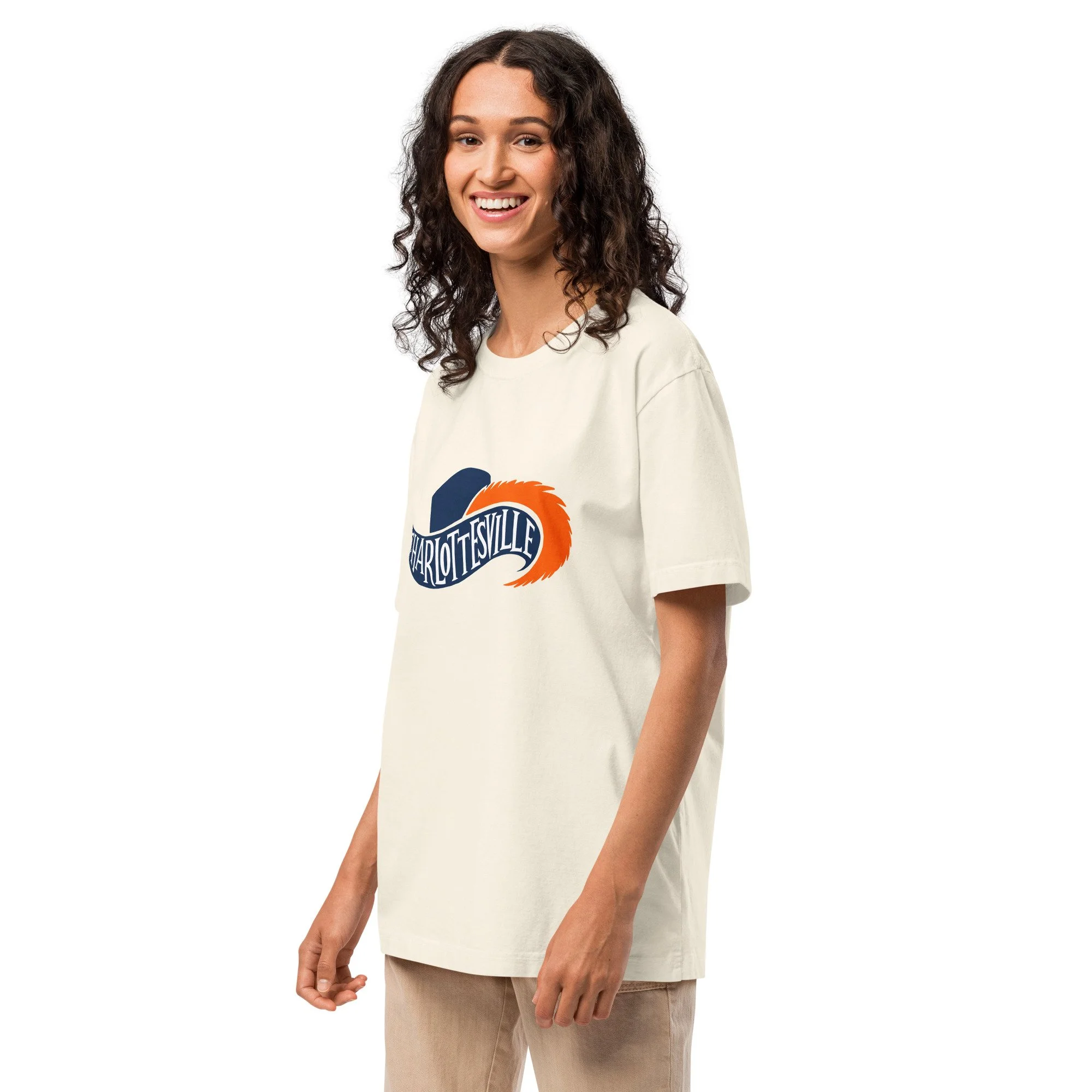 Woman wearing Charlottesville Virginia oversized heavyweight t-shirt in vintage white with navy and orange Cavalier hat and feathered plume design, original Kittonix design for UVA fans