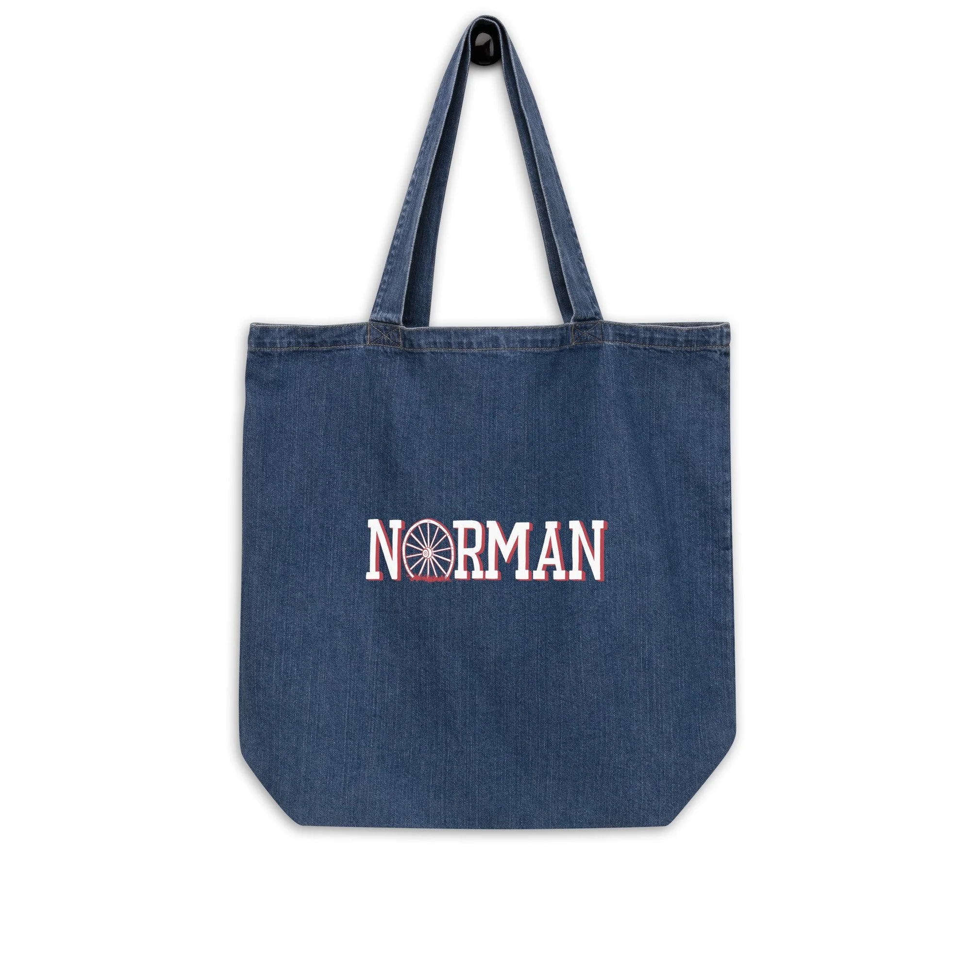 Norman Oklahoma organic denim tote bag in dark wash with hand-drawn Norman wagon wheel graphic on front.