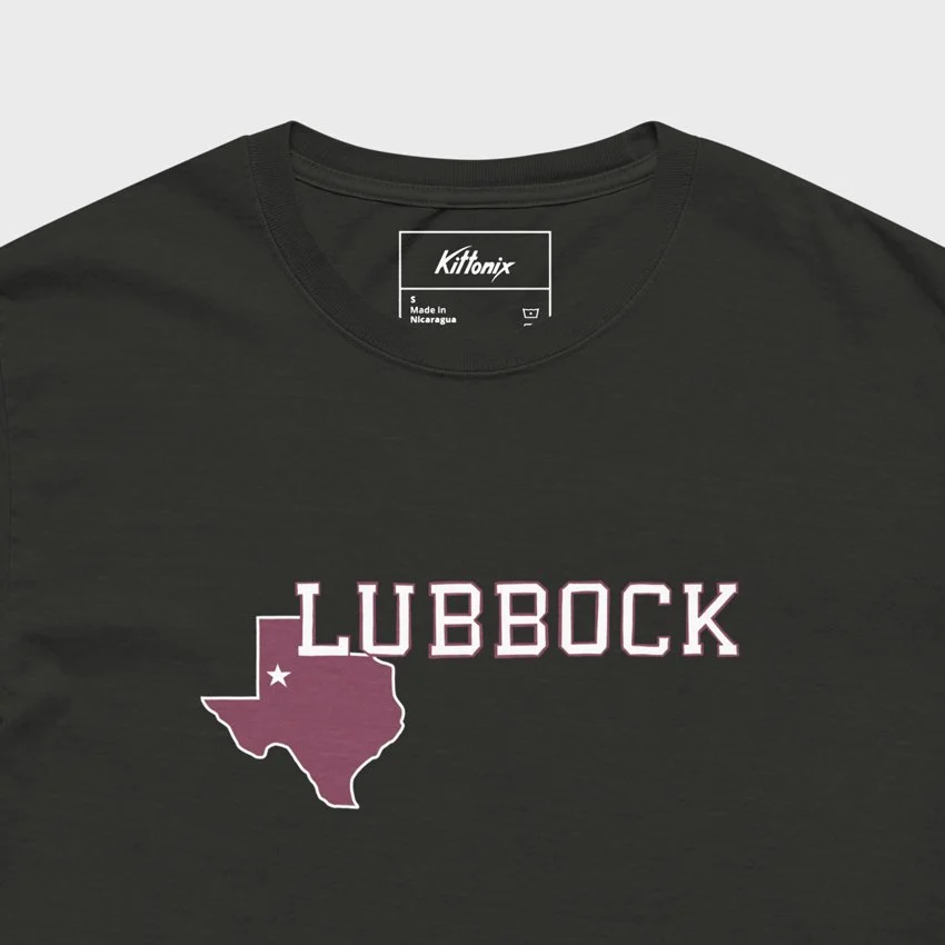 Close-up of black Lubbock tee with Texas outline and white collegiate font. Oversized heavyweight cotton inspired by Texas Tech’s hometown.