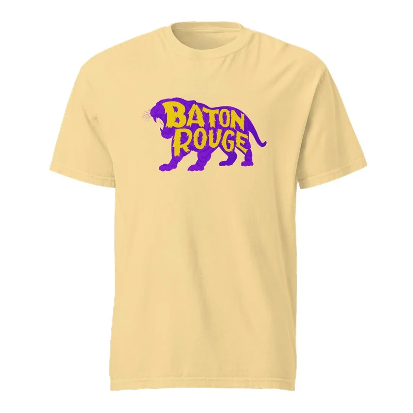 Baton Rouge Louisiana garment-dyed t-shirt in butter with purple tiger silhouette and jagged gold lettering design, original Kittonix design for LSU fans