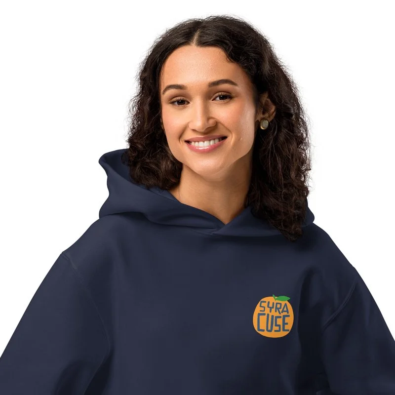 Woman wearing a navy hoodie with a Syracuse orange logo on the left chest.