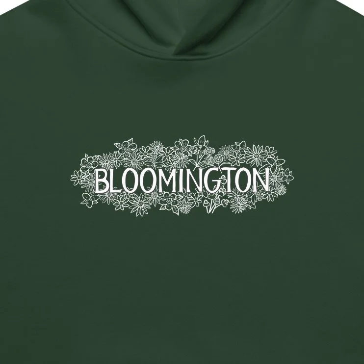 Close-up of white floral Bloomington text on green crewneck, inspired by IU’s campus style.