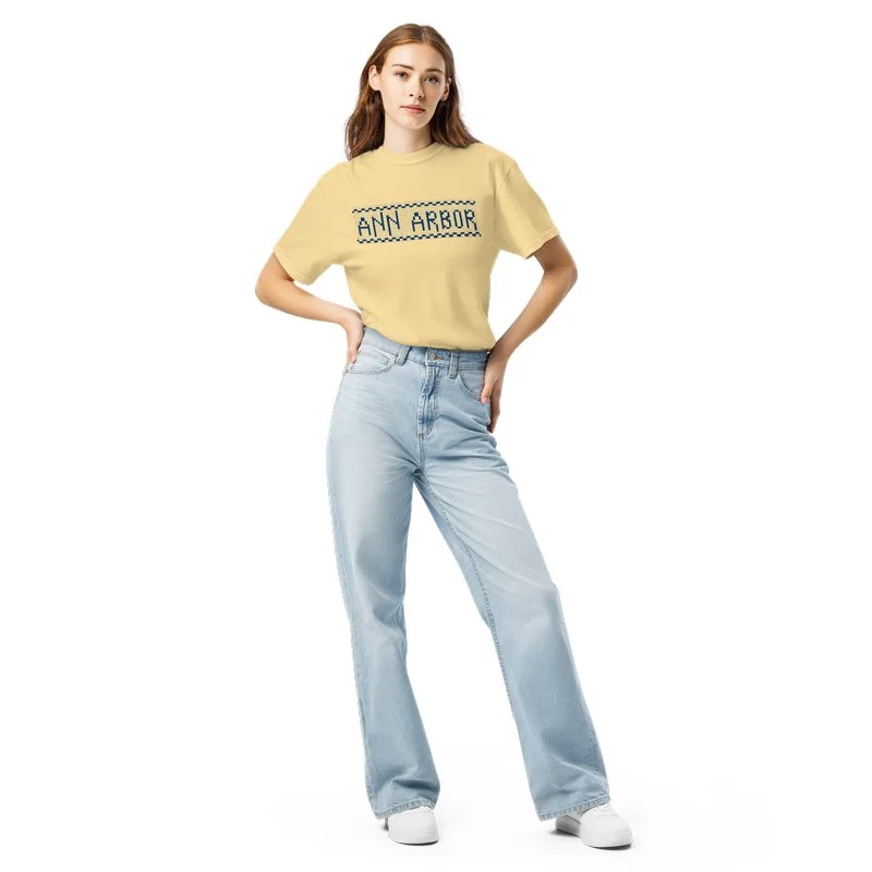 Female model wearing the Ann Arbor "Zingerman's" design on a garment dyed t-shirt in yellow.