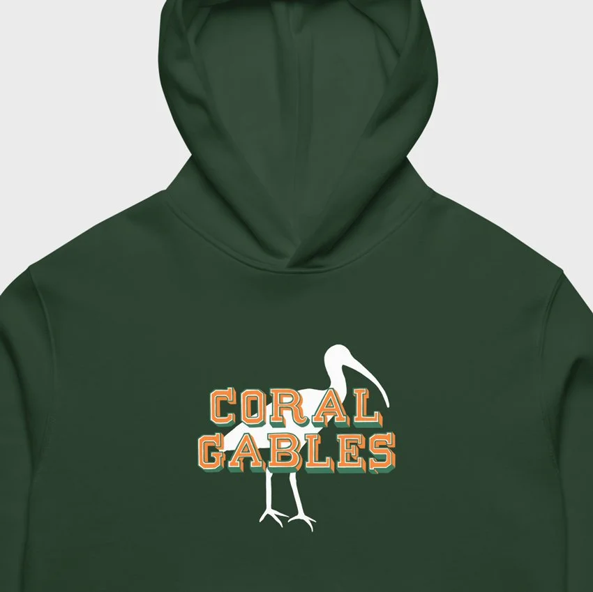 Closeup of a forest green oversized hoodie with Coral Gables ibis design, inspired by the hometown of the Miami Hurricanes.