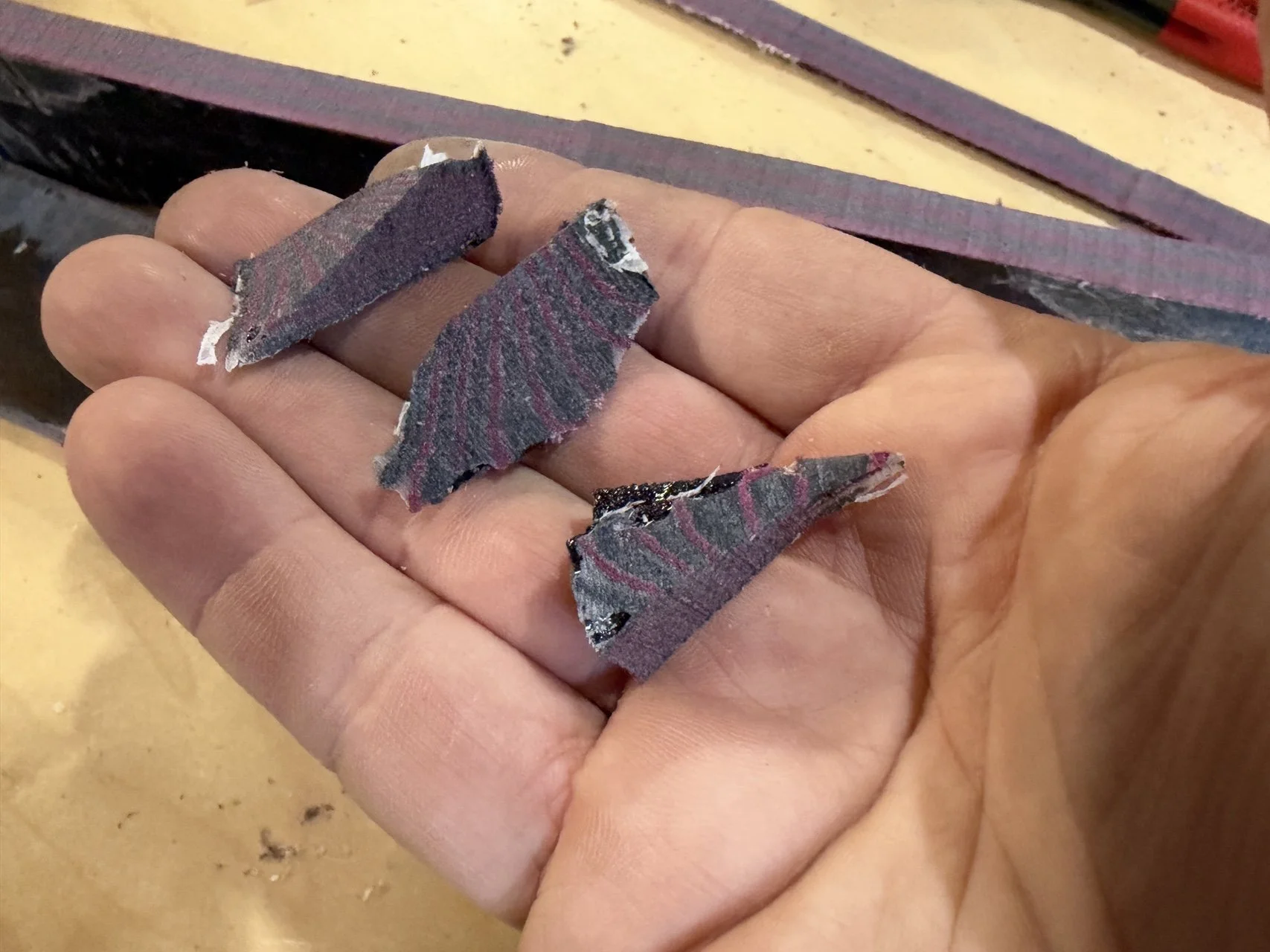 Micarta scraps showing the different patterns exposed by removing material