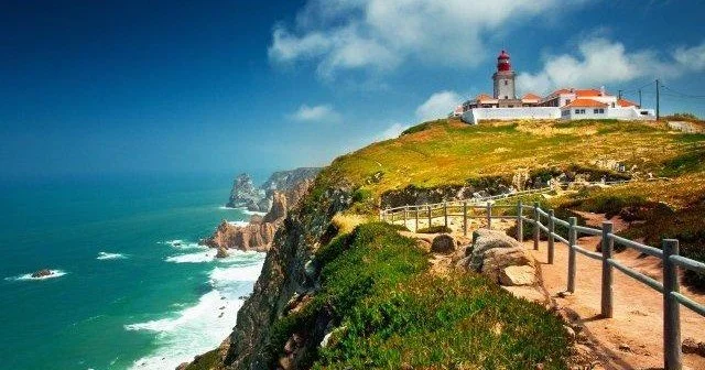 Lighthouse on the rocky cliffs of Cabo da Roc, Europe's most western point, in Sintra Cascais National Park.