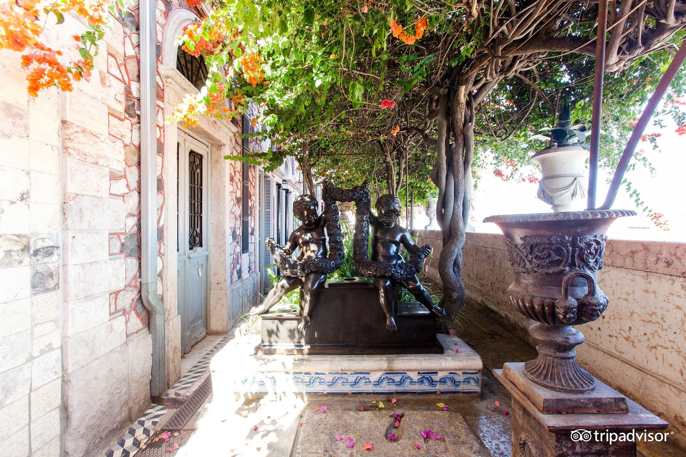 Decorative garden with statues and foliage at the Palacete Chafariz Del Rei Lisbon in the Alfama district.