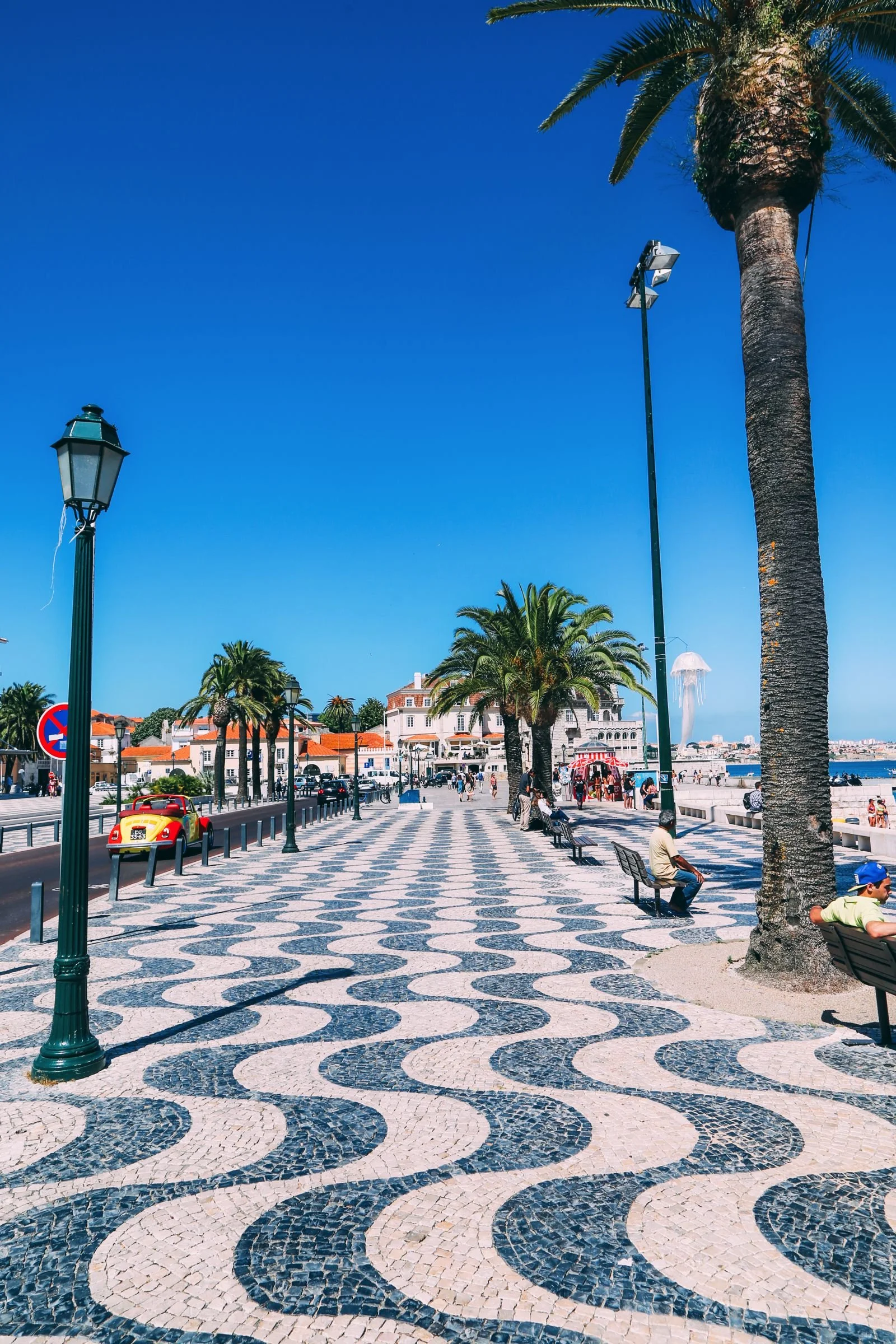 Cascais promenade main square with Portuguese wave-patterned black and white mosaic tiles along the oceanfront