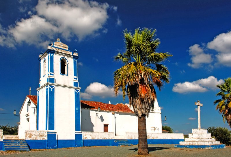 Whitewashed church with blue trim in the Alentejo countryside