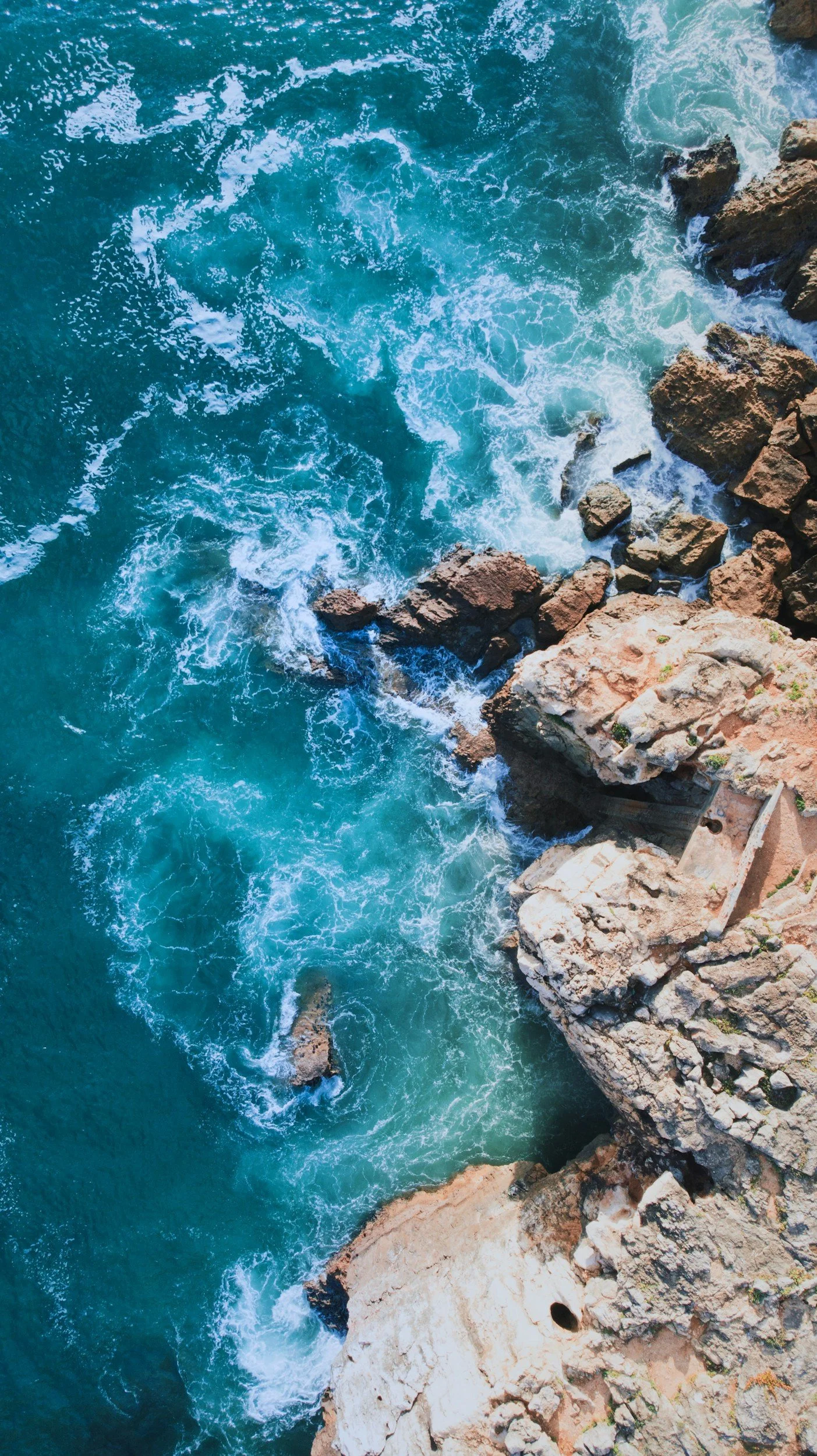 Rocky shoreline and waves along the Atlantic coast in Cascais