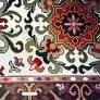 Close-up of red, white, and green embroidered pattern on an Arraiolos rug
