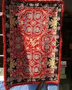 Red Arraiolos rug hanging from a windowsill in Arraiolos