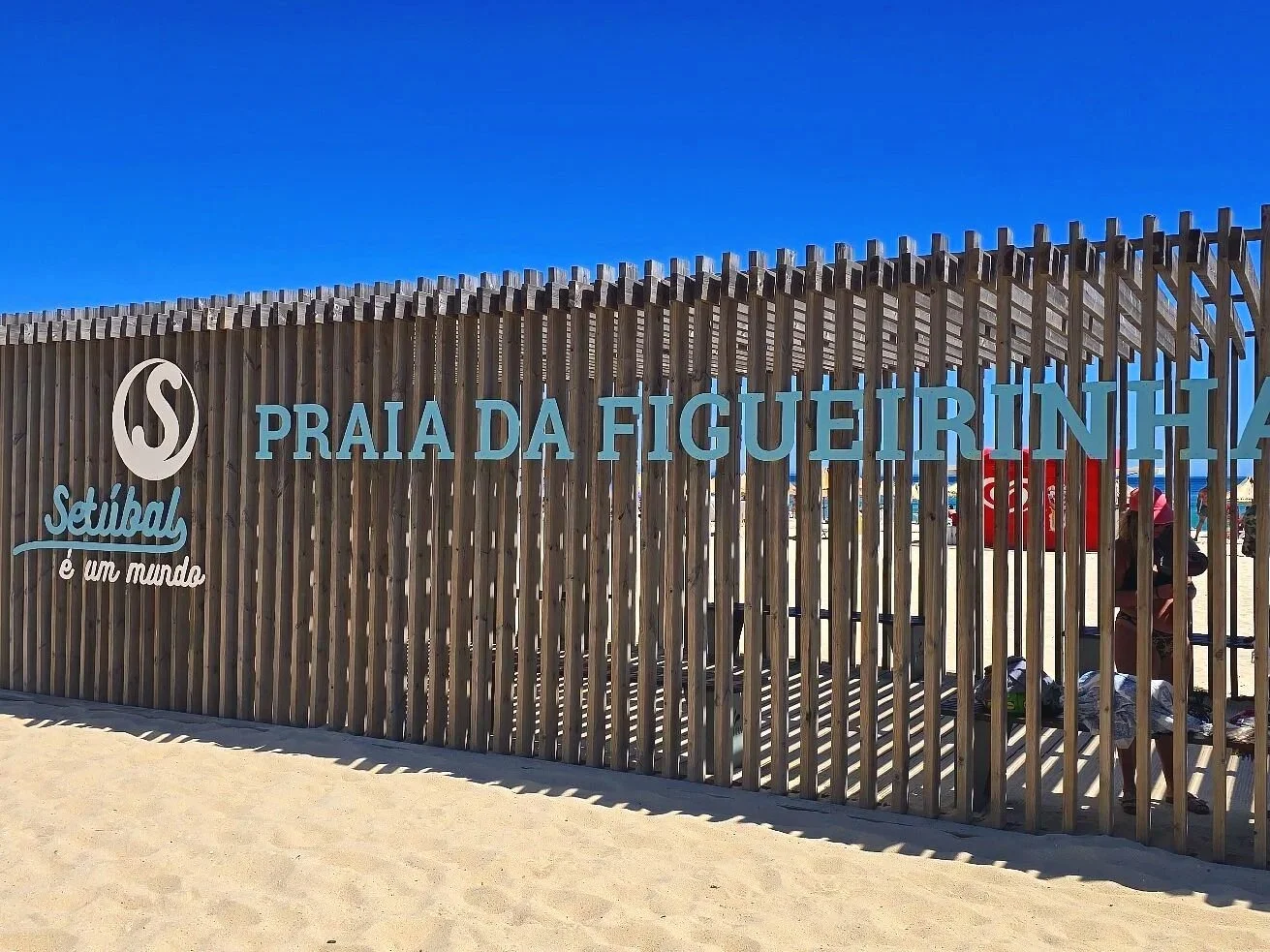 Beachfront sign marking Praia da Figueirinha