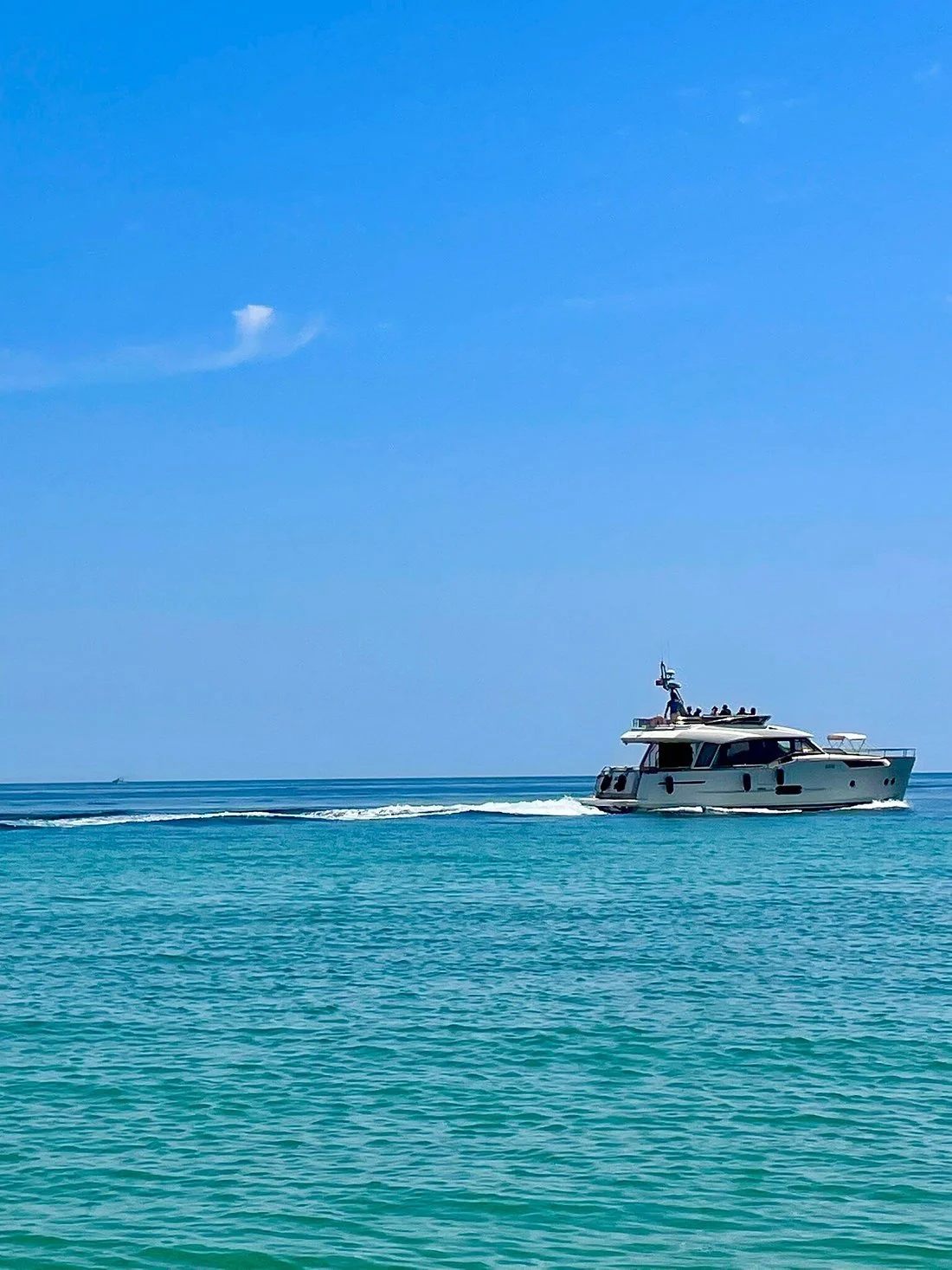 Boat cruising along the coastline near Sesimbra in Arrábida Natural Park