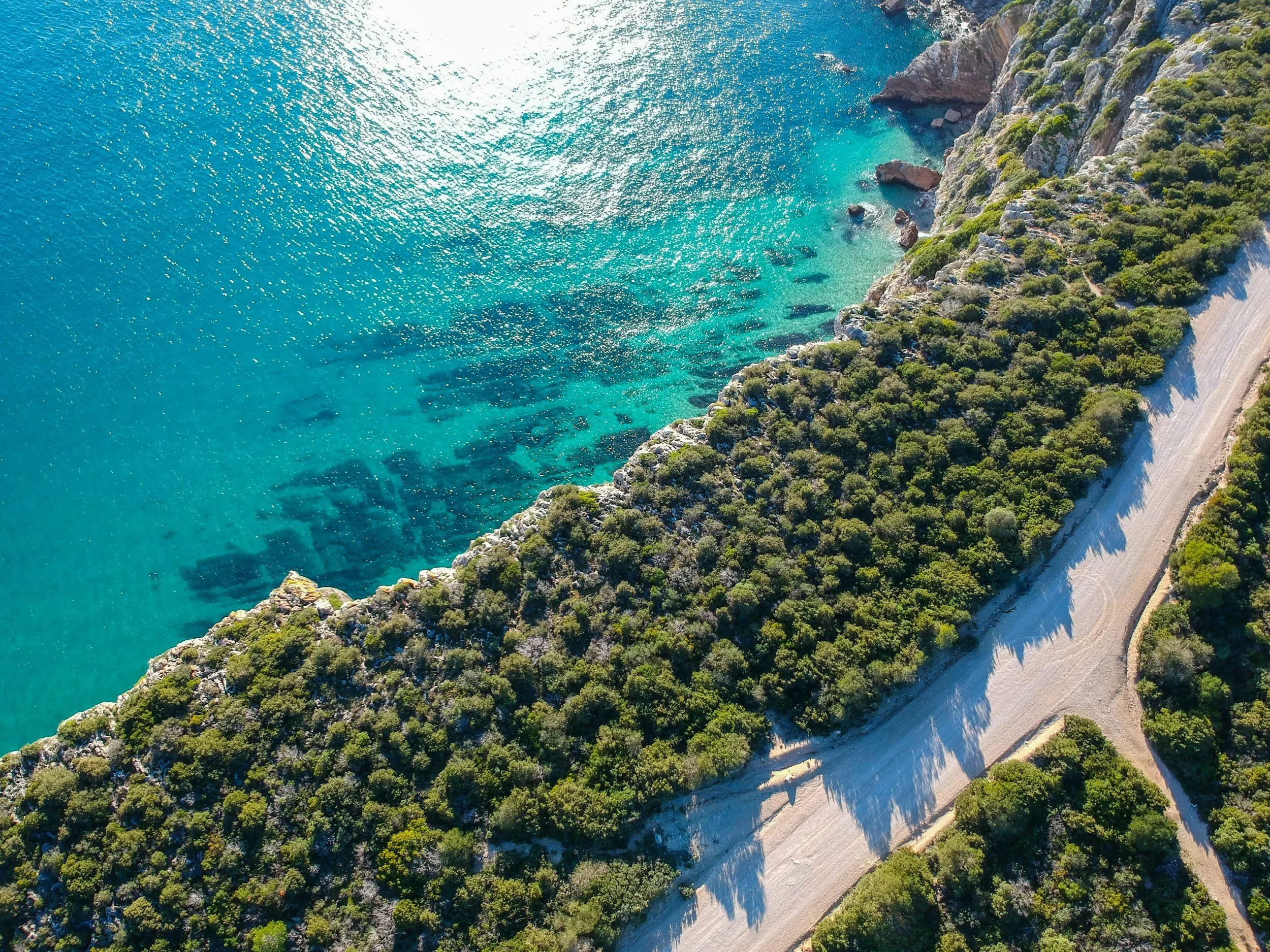 Cliffs and blue water along the coast near Setúbal in Arrábida Natural Park