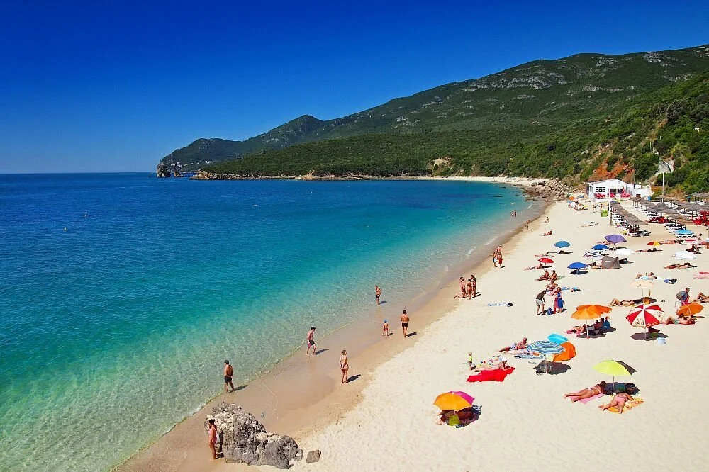 praia-de-galapinhos-beachgoers-swimming-sunbathing-arrabida-portugal.webp